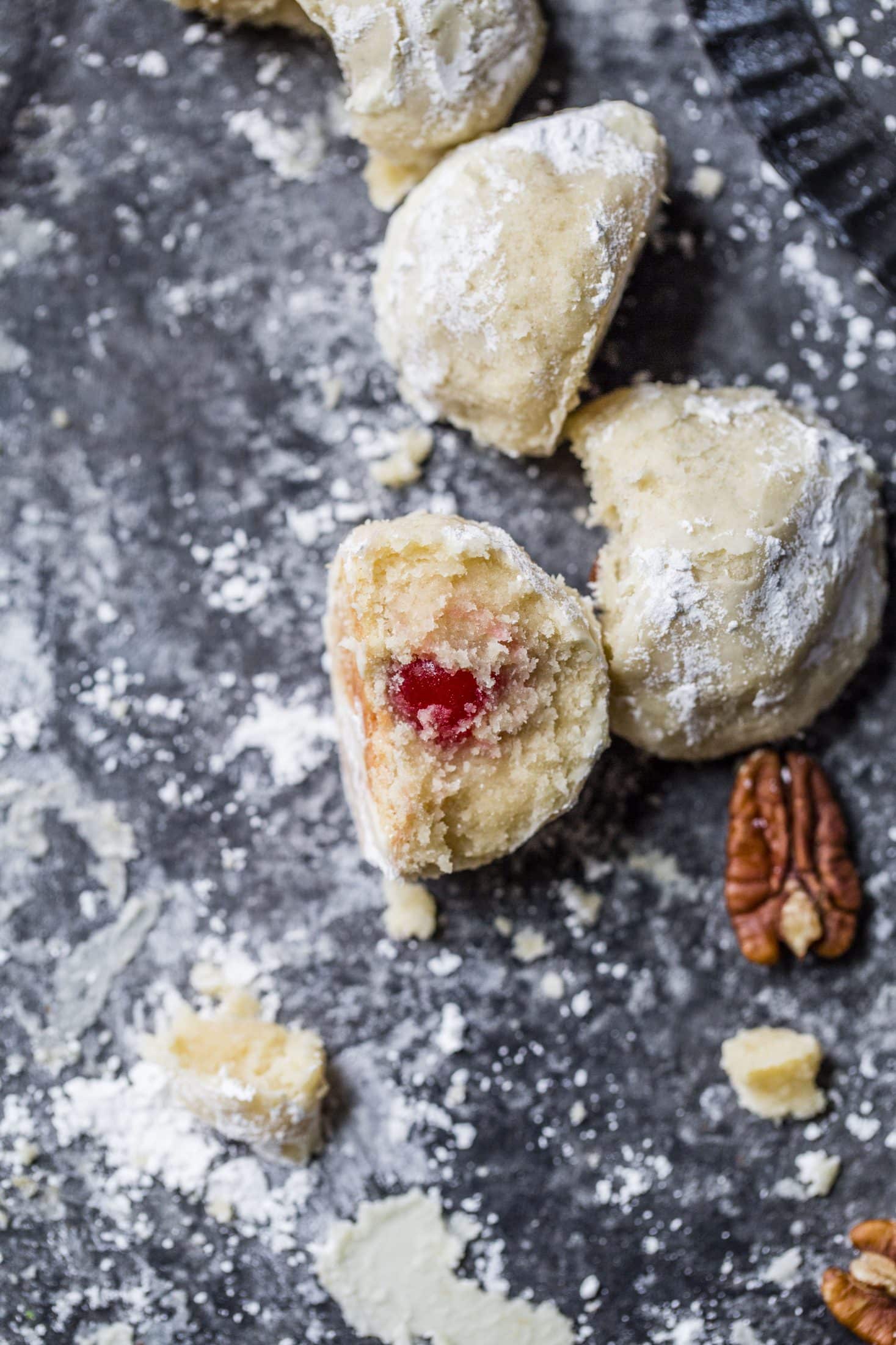 These classic butterball cookies are a favorite that my grandmother made every year at Christmas. They are a light cookie that isn't super sweet and the center is filled with either a pecan or maraschino cherry. Classic and delicious! I howsweeteats.com #butterball #cookies