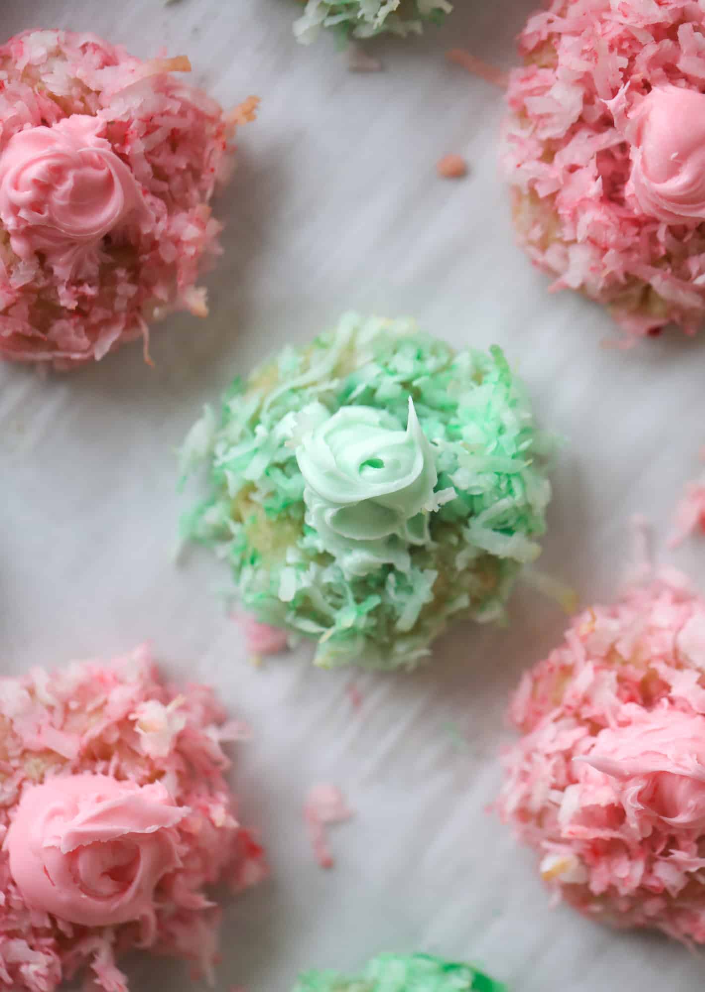 These thumbprint cookies are so perfect for the holiday season. The best butter thumbprint rolled in pink and green coconut and filled with buttercream. So festive! I personally think they look like Grinch cookies - kids love them! I howsweeteats.com #thumbprint #cookies