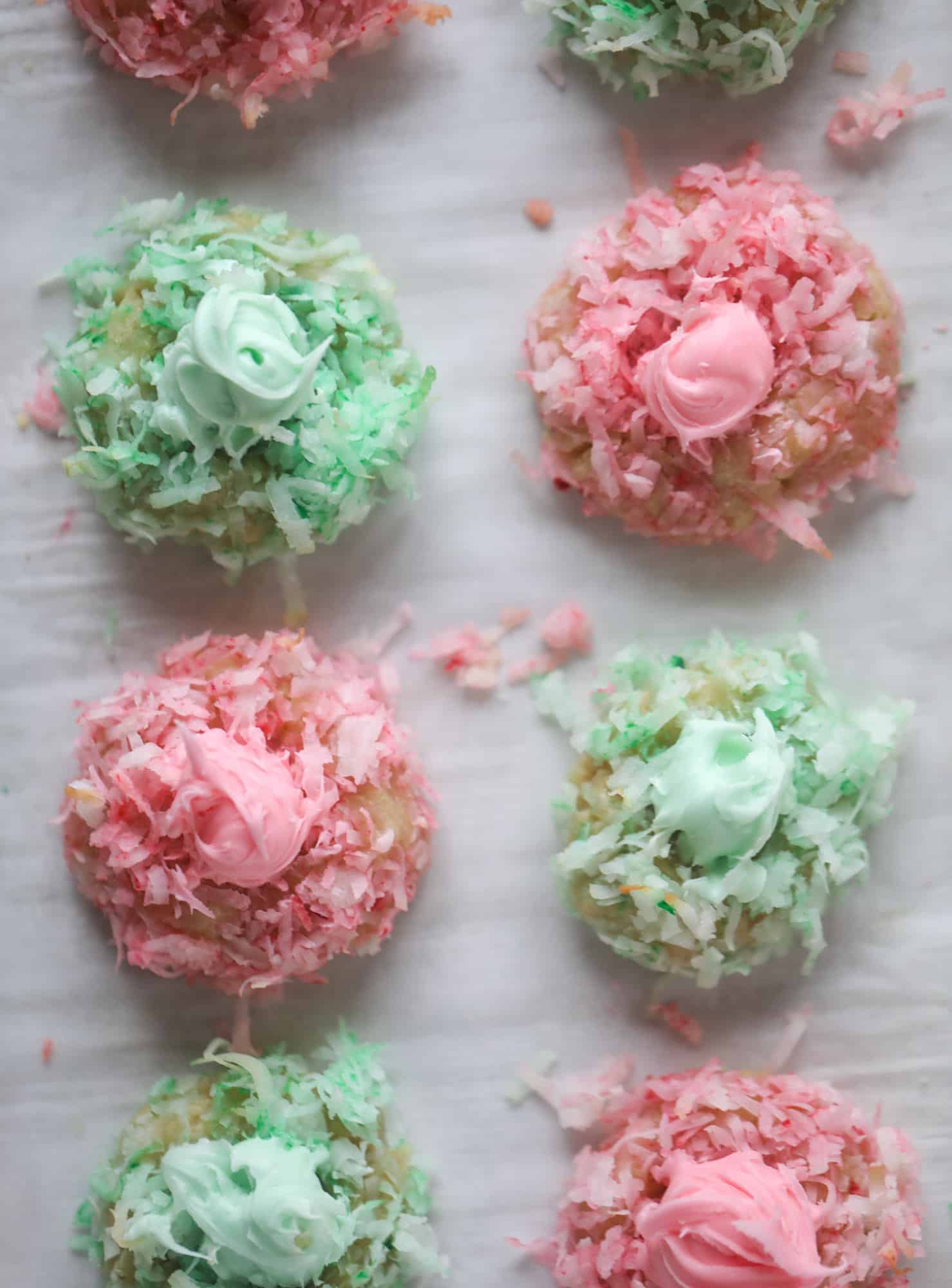 These thumbprint cookies are so perfect for the holiday season. The best butter thumbprint rolled in pink and green coconut and filled with buttercream. So festive! I personally think they look like Grinch cookies - kids love them! I howsweeteats.com #thumbprint #cookies