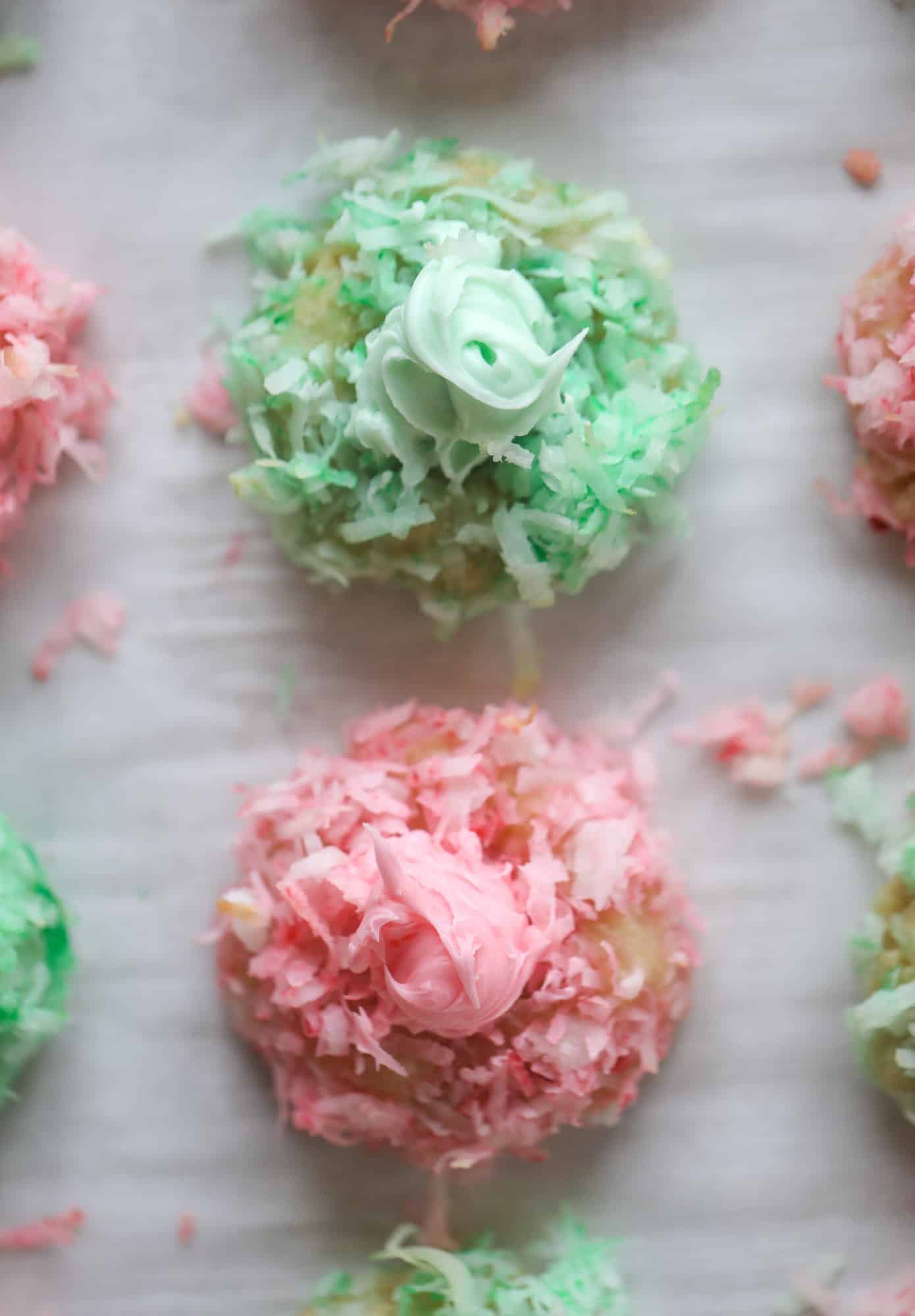 These thumbprint cookies are so perfect for the holiday season. The best butter thumbprint rolled in pink and green coconut and filled with buttercream. So festive! I personally think they look like Grinch cookies - kids love them! I howsweeteats.com #thumbprint #cookies