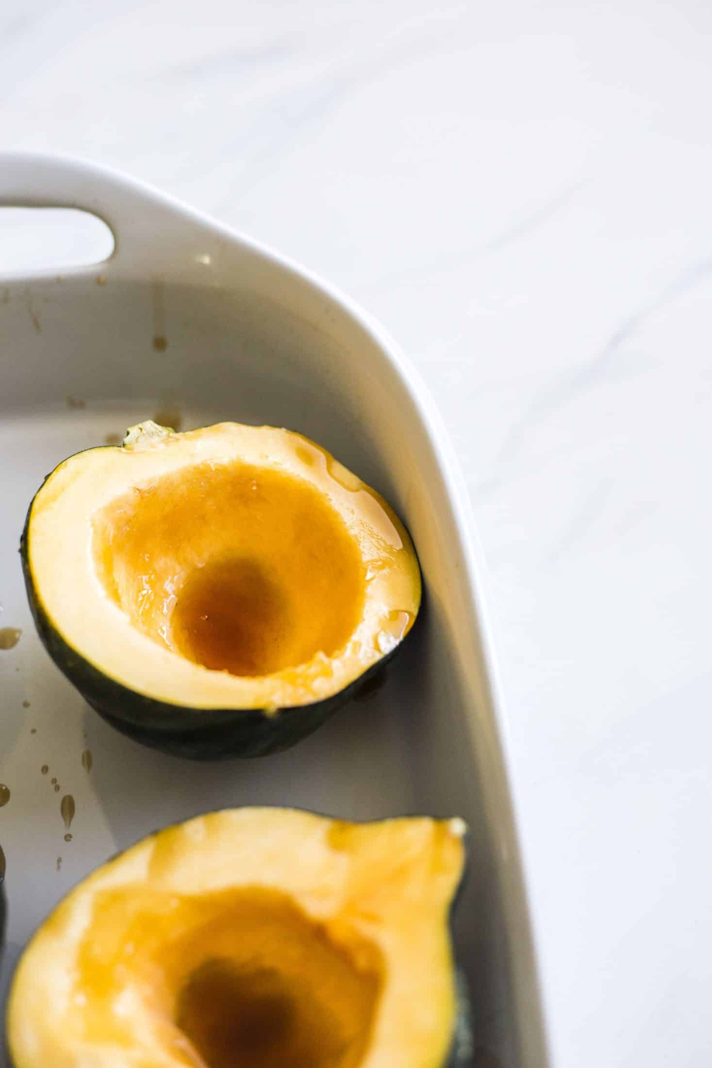 This baked acorn squash recipe is so delicious for the fall! It's made with vanilla and bourbon, finished with balsamic, is super easy, a bit indulgent and perfect for the season. Makes for a fabulous side dish in autumn or even a dessert! I howsweeteats.com #acorn #squash #baked #vanilla #bourbon