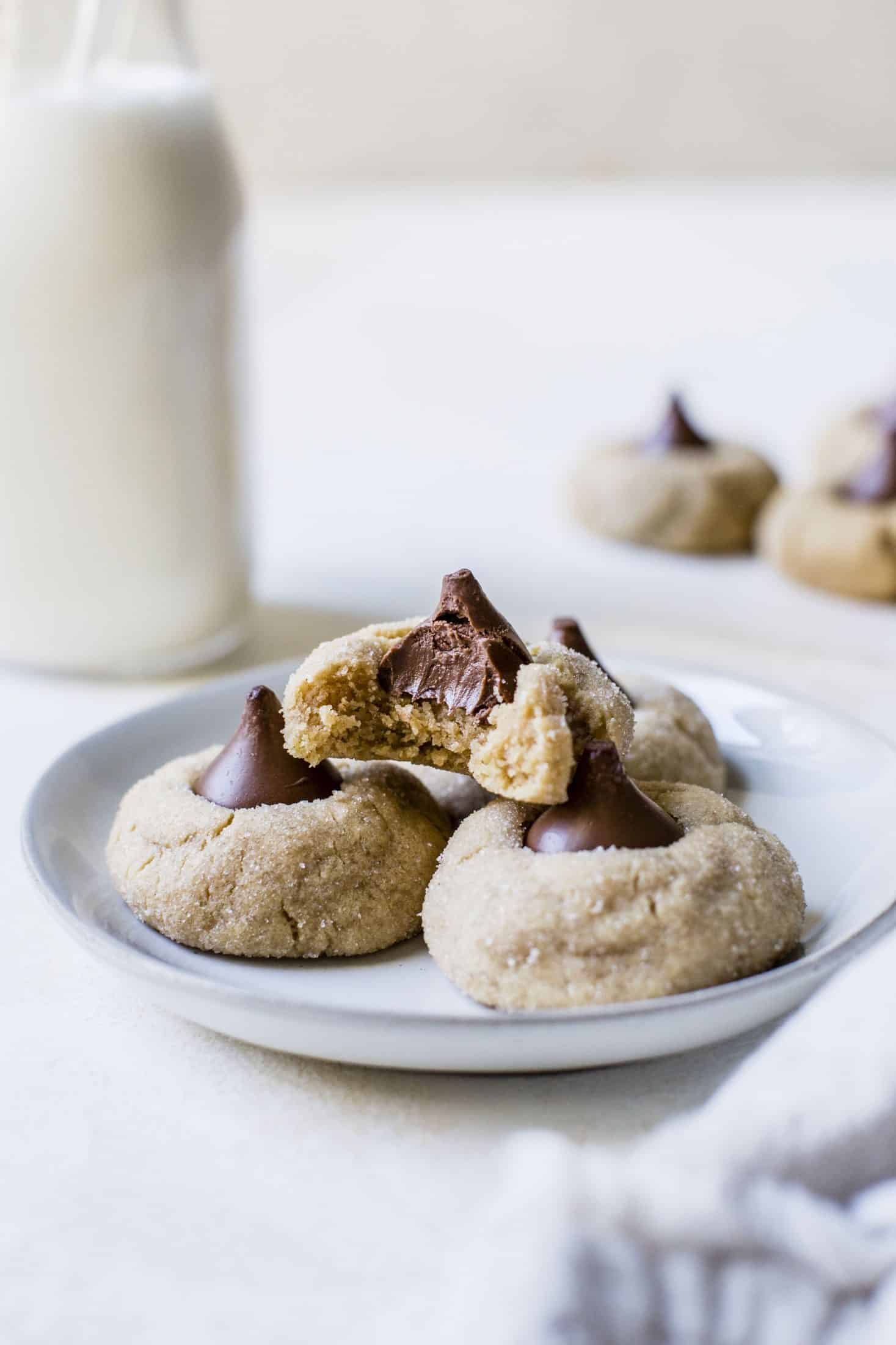 These are perfect peanut butter blossoms! My favorite cookie at christmastime has always been classic peanut butter blossoms and my grandma had the recipe nailed. These are super easy, delicious and will make a lot of cookies! I howsweeteats.com #peanutbutter #blossoms