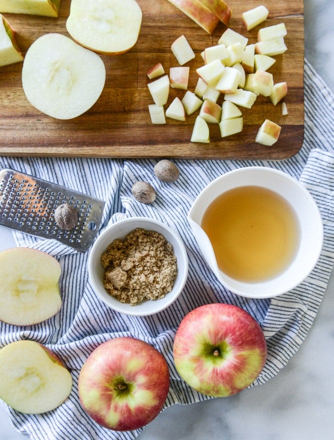 vanilla cinnamon roll dutch baby with apple bourbon compote and cream cheese icing I howsweeteats.com