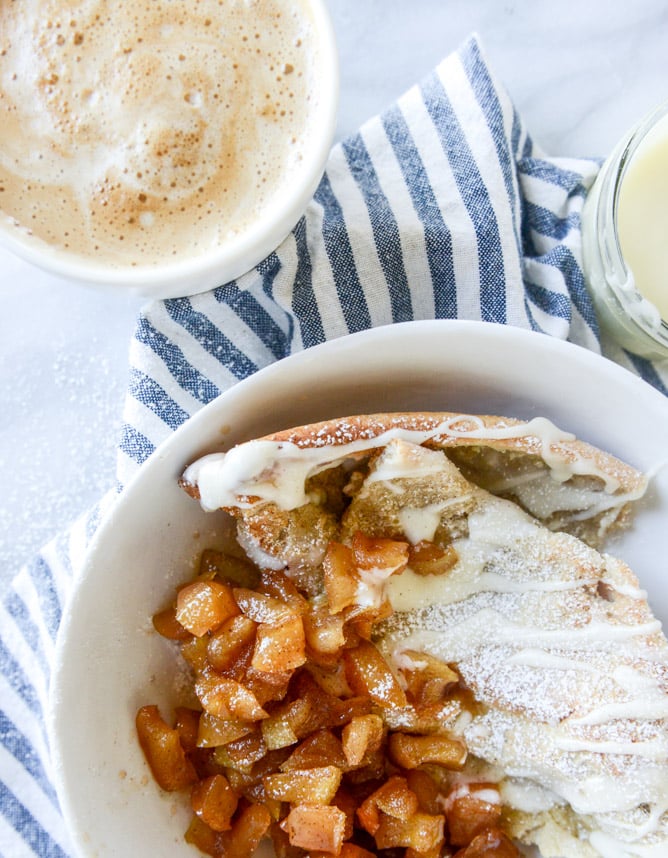 vanilla cinnamon roll dutch baby with apple bourbon compote and cream cheese icing I howsweeteats.com