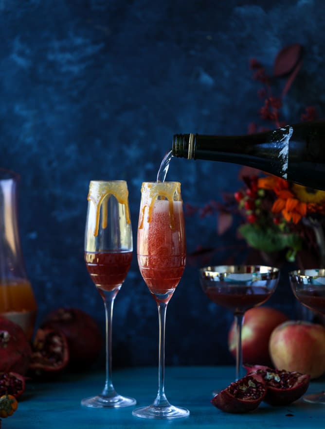 pomegranate cider mimosas with a salted caramel rim I howsweeteats.com #cocktails #thanksgiving #applecider #mimosas