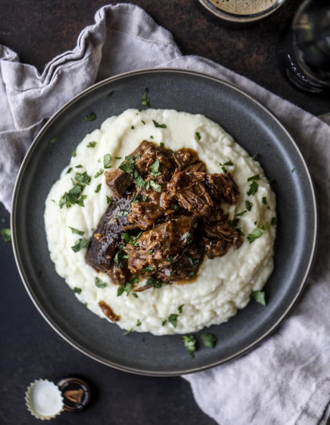 guinness short ribs with cheesy cauliflower mash I howsweeteats.com #slowcooker #guinness #shortribs #saintpatricksday #cauliflower