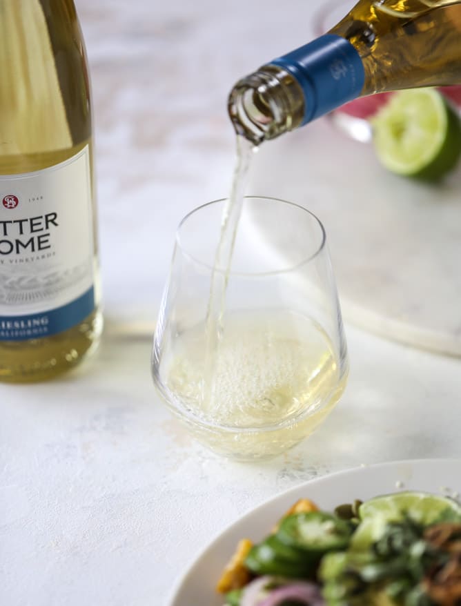 This spicy rainbow salad is chock full of gorgeous, fresh produces, chickpeas, plantains and herbs for one beautiful sight in a bowl. The rainbow salad is satisfying, filling, delicious with a touch of sweet and slightly spicy - everything you want in a meal! I howsweeteats.com #spicy #rainbow #salad 