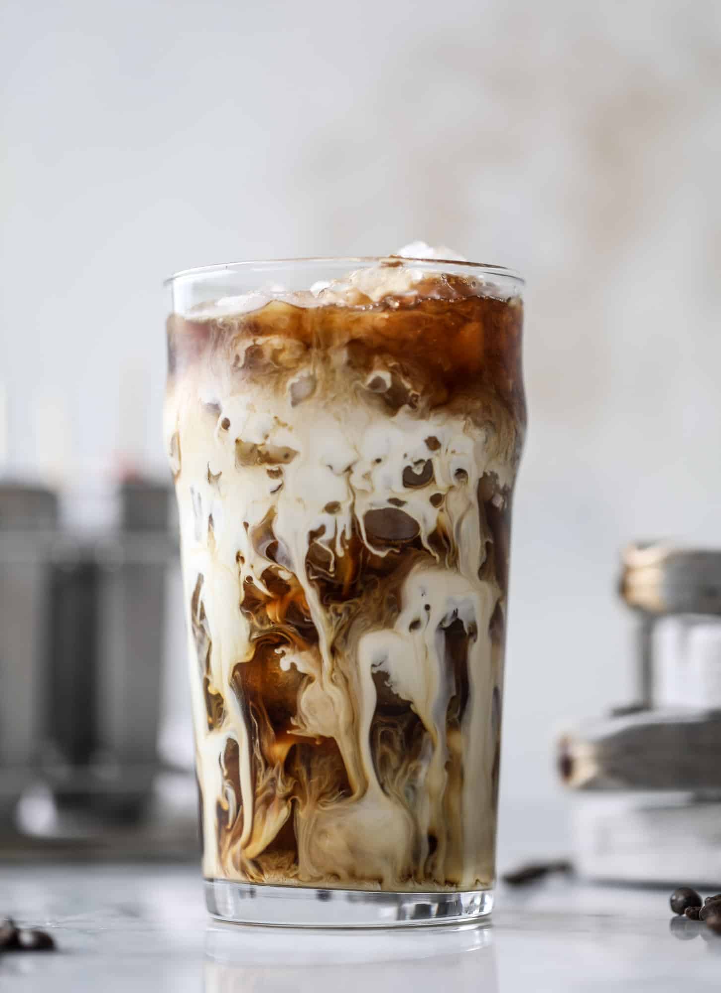 These fudgesicles are made with cold brew and dutch process cocoa for the most fun grown-up popsicle that can also deliver a little caffeine jolt. Topped with vanilla bean sweet cream, these are just like an iced latte in a pop! Serve as a treat or a snack! I howsweeteats.com #coldbrew #coffee #sweet #cream #popsicle #fudgesicle