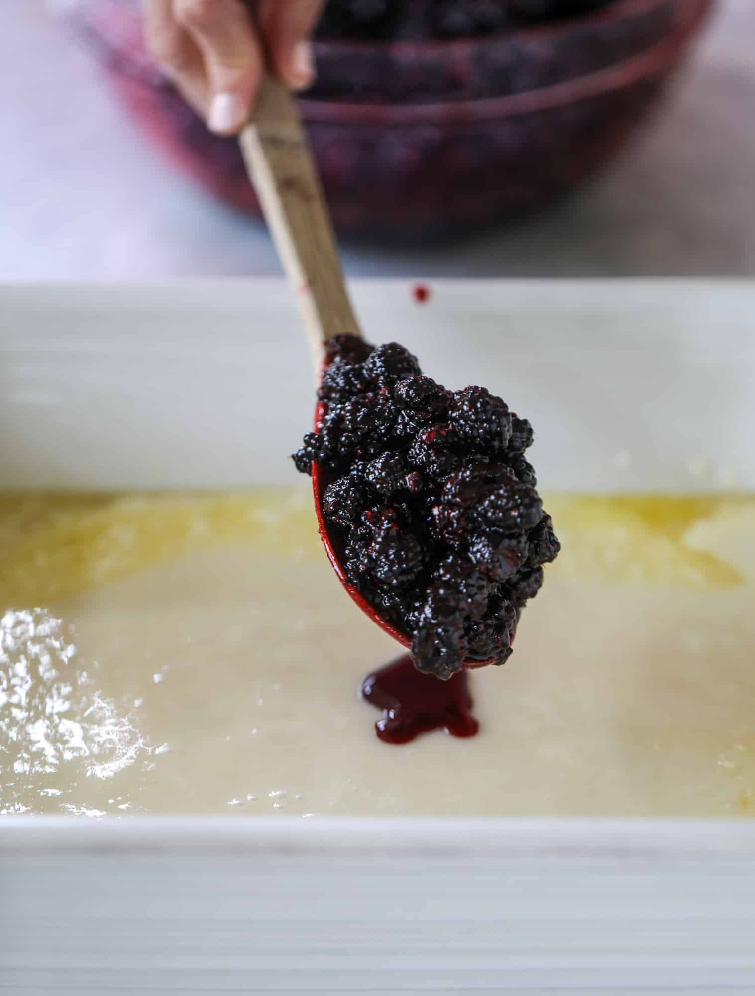 This black raspberry cobbler is a summer dream come true! The bursting black raspberries are rich and sweet, then add in a touch of lavender for incredible flavor and you're all set. The cobbler cake topping is perfect for vanilla ice cream. Win! I howsweeteats.com #black #raspberry #cobbler #lavender #summer #desserts #icecream