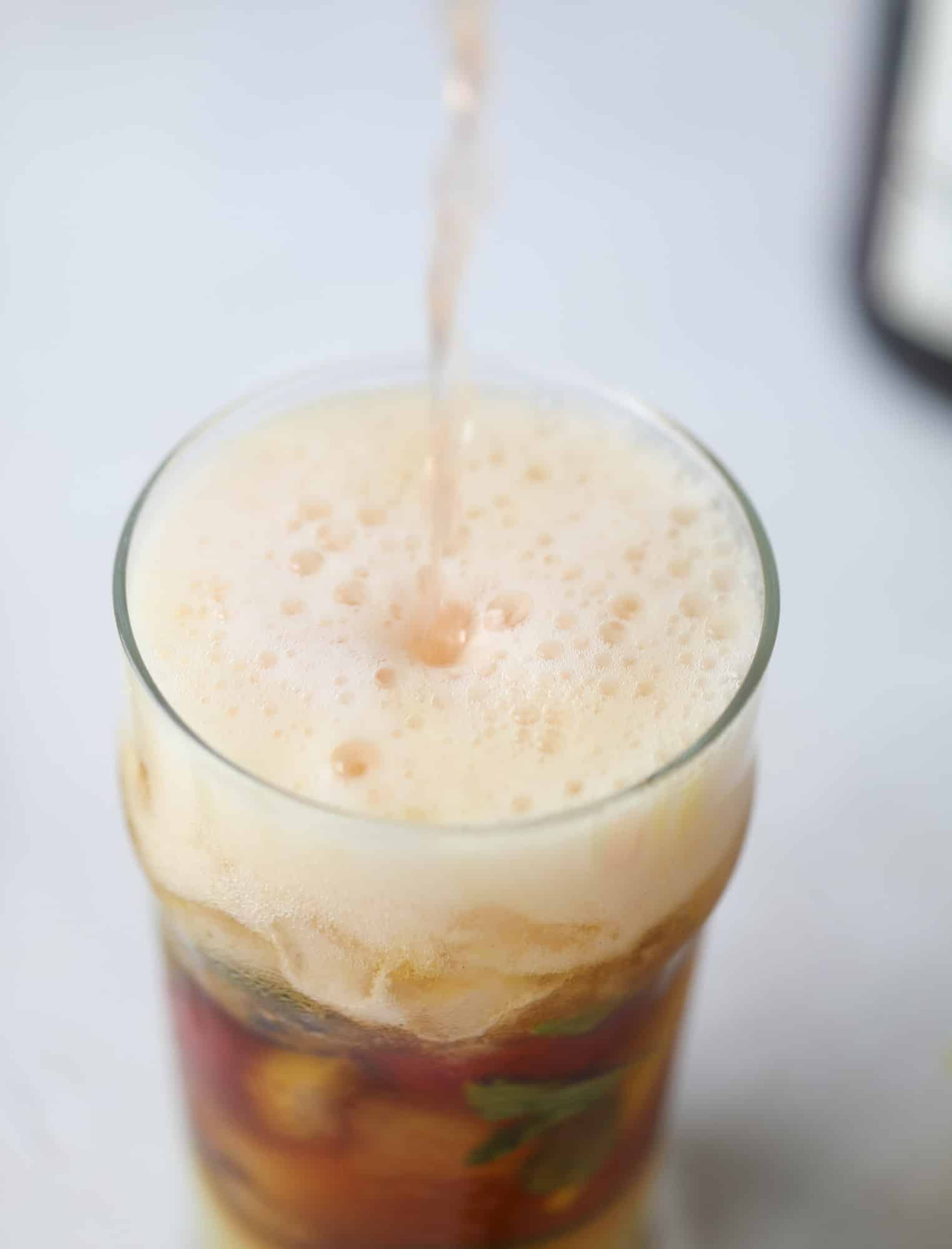 I love a delicious Pimm's Cup in the heart of summer! This was is topped with sparkling rosé wine and filled with strawberries, cucumbers and lemon wedges. It's super refreshing and perfect on hot hot days! I howsweeteats.com #pimms #cup #recipe #cocktails #rosé #sparkling #summer