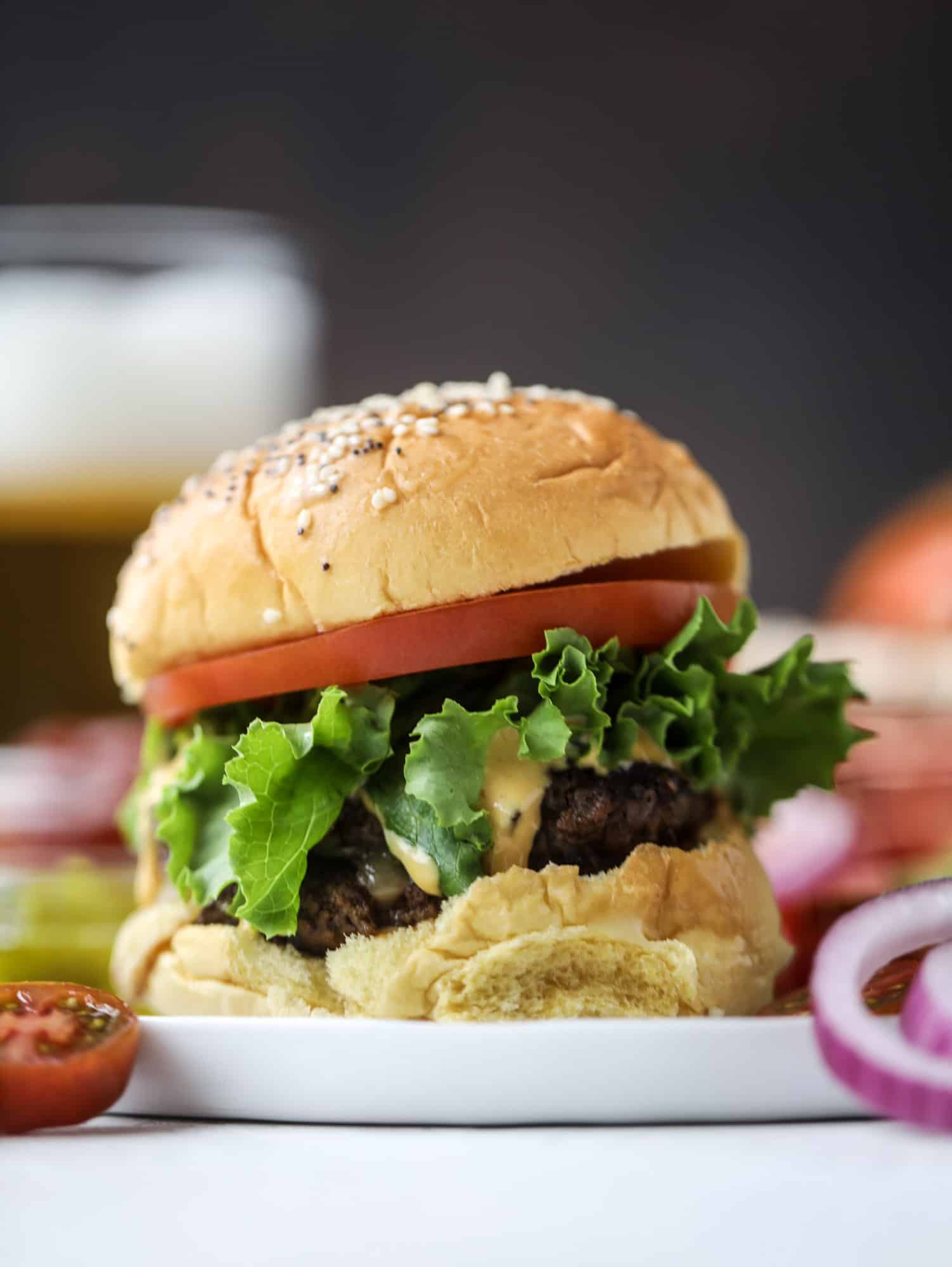 These smash burgers are to die for! All you need are a few ingredients and 30 minutes to make these smash burgers happen. Topped with melty smoked gouda and topped with a creamy, tangy house sauce, these are the best burgers ever! I howsweeteats.com #smash #burgers #smoked #gouda #special #sauce