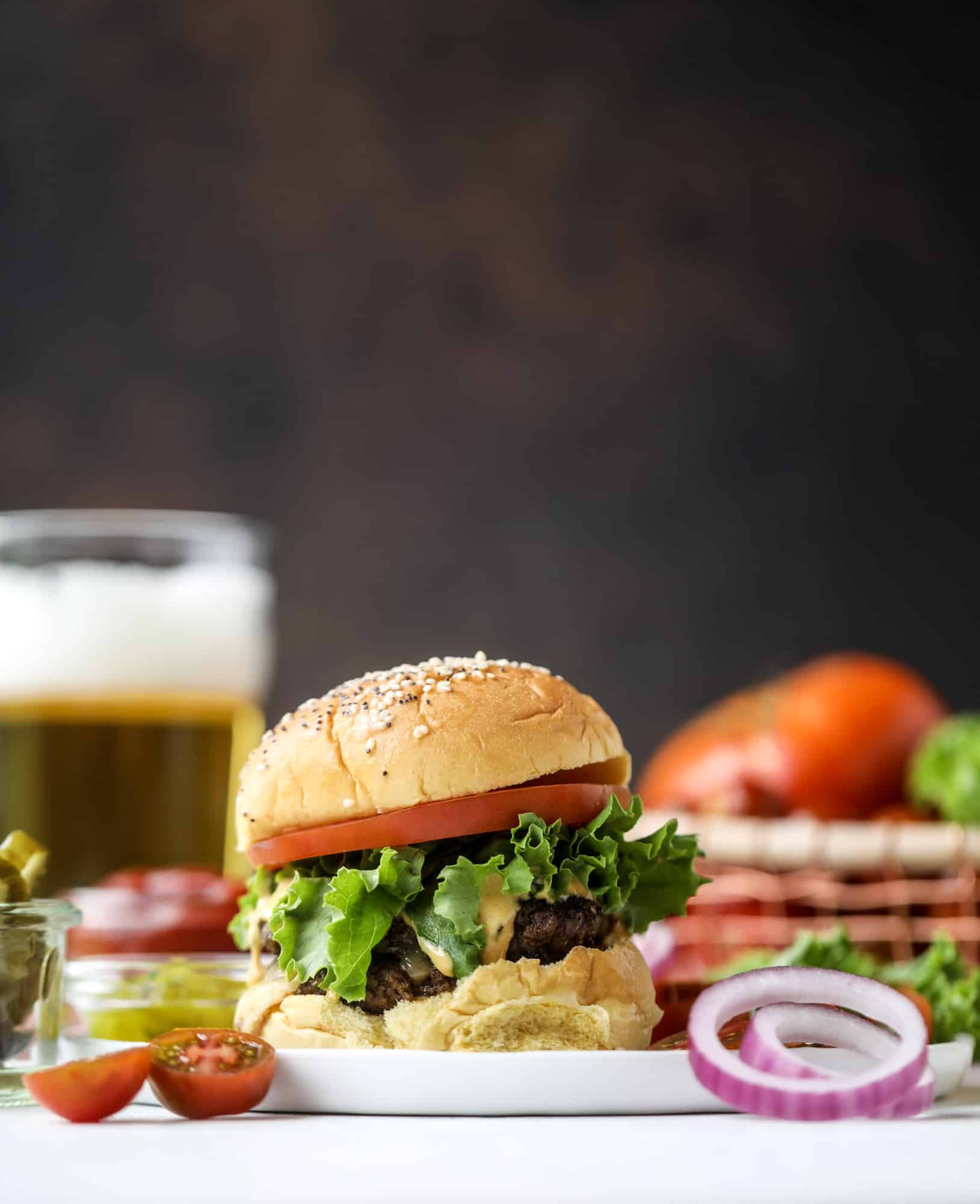 These smash burgers are to die for! All you need are a few ingredients and 30 minutes to make these smash burgers happen. Topped with melty smoked gouda and topped with a creamy, tangy house sauce, these are the best burgers ever! I howsweeteats.com #smash #burgers #smoked #gouda #special #sauce