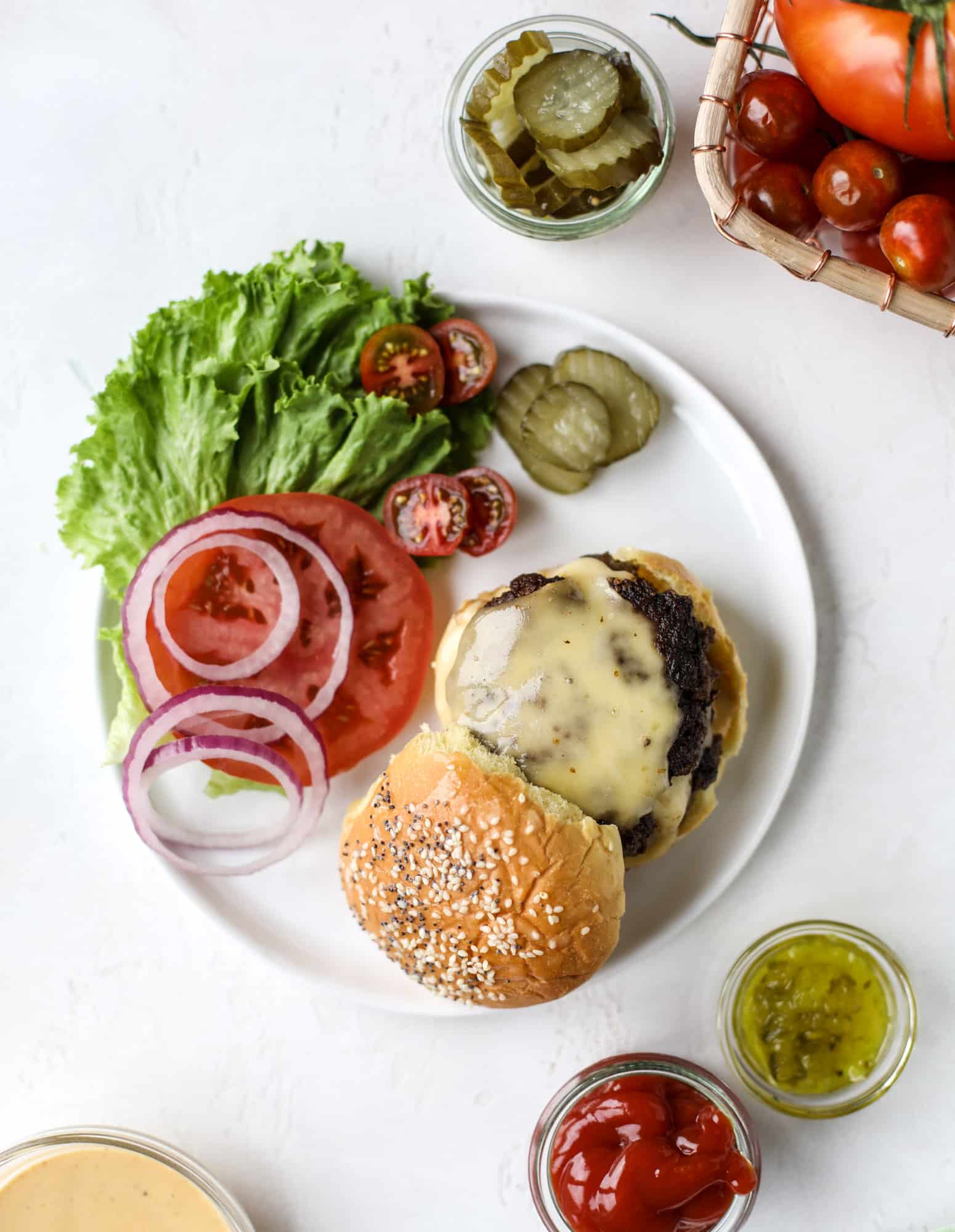 These smash burgers are to die for! All you need are a few ingredients and 30 minutes to make these smash burgers happen. Topped with melty smoked gouda and topped with a creamy, tangy house sauce, these are the best burgers ever! I howsweeteats.com #smash #burgers #smoked #gouda #special #sauce