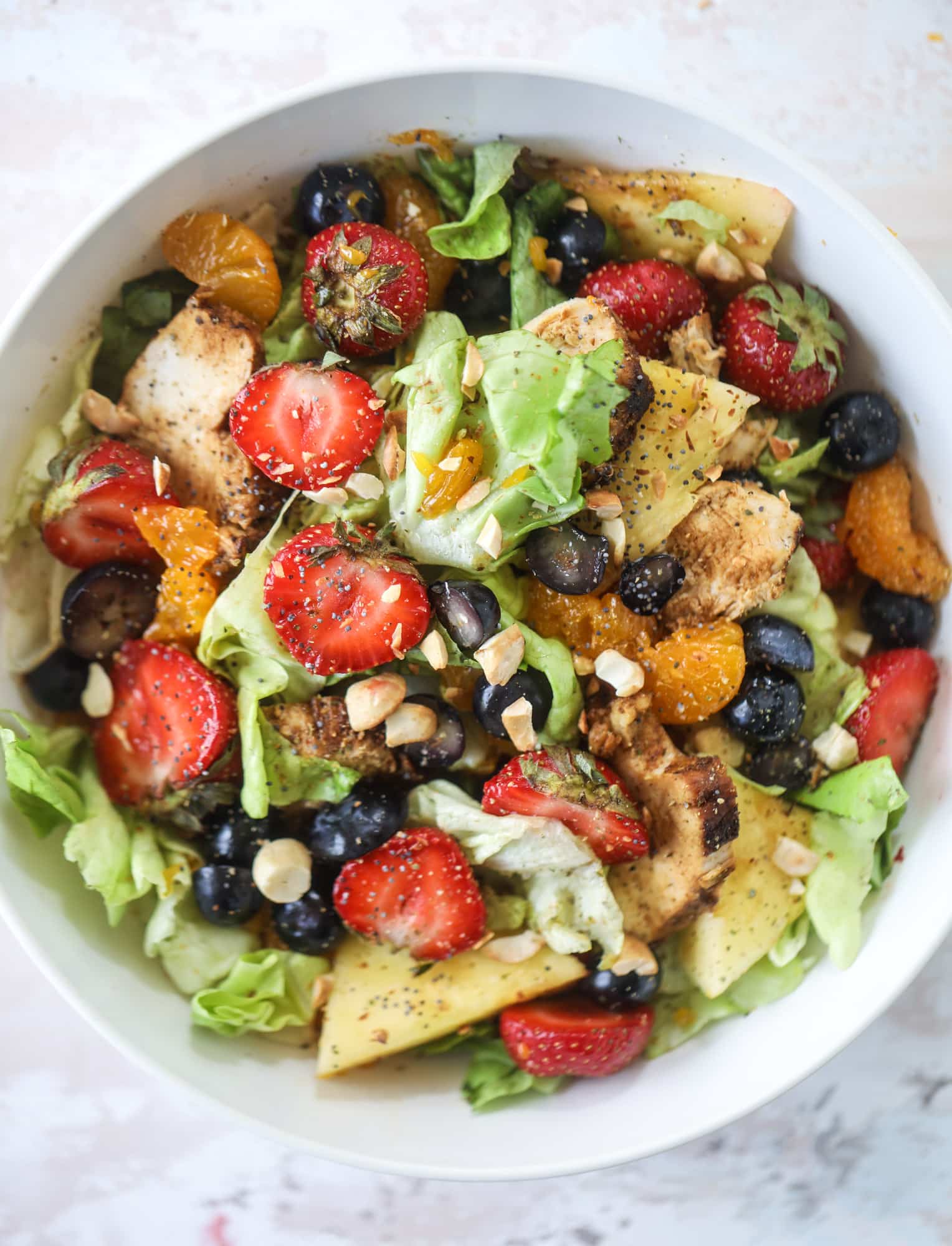 This copycat Panera strawberry poppyseed salad is absolutely delicious and refreshing and perfect for summer! Serve it with grilled chicken like the recipe here or swap for shrimp or fish. I howsweeteats.com #strawberry #poppyseed #salad #chicken #panera #copycat