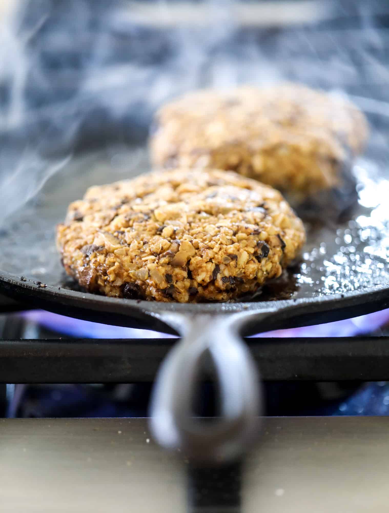 This is the best ever veggie burger and that is not an exaggeration! It's delicious, full of texture and chew, super satisfying and actually sticks together in the pan. You can serve it on buns, make a patty melt, a salad or lettuce wraps - perfection! I howsweeteats.com #best #veggie #burger #vegetarian #beans #quinoa