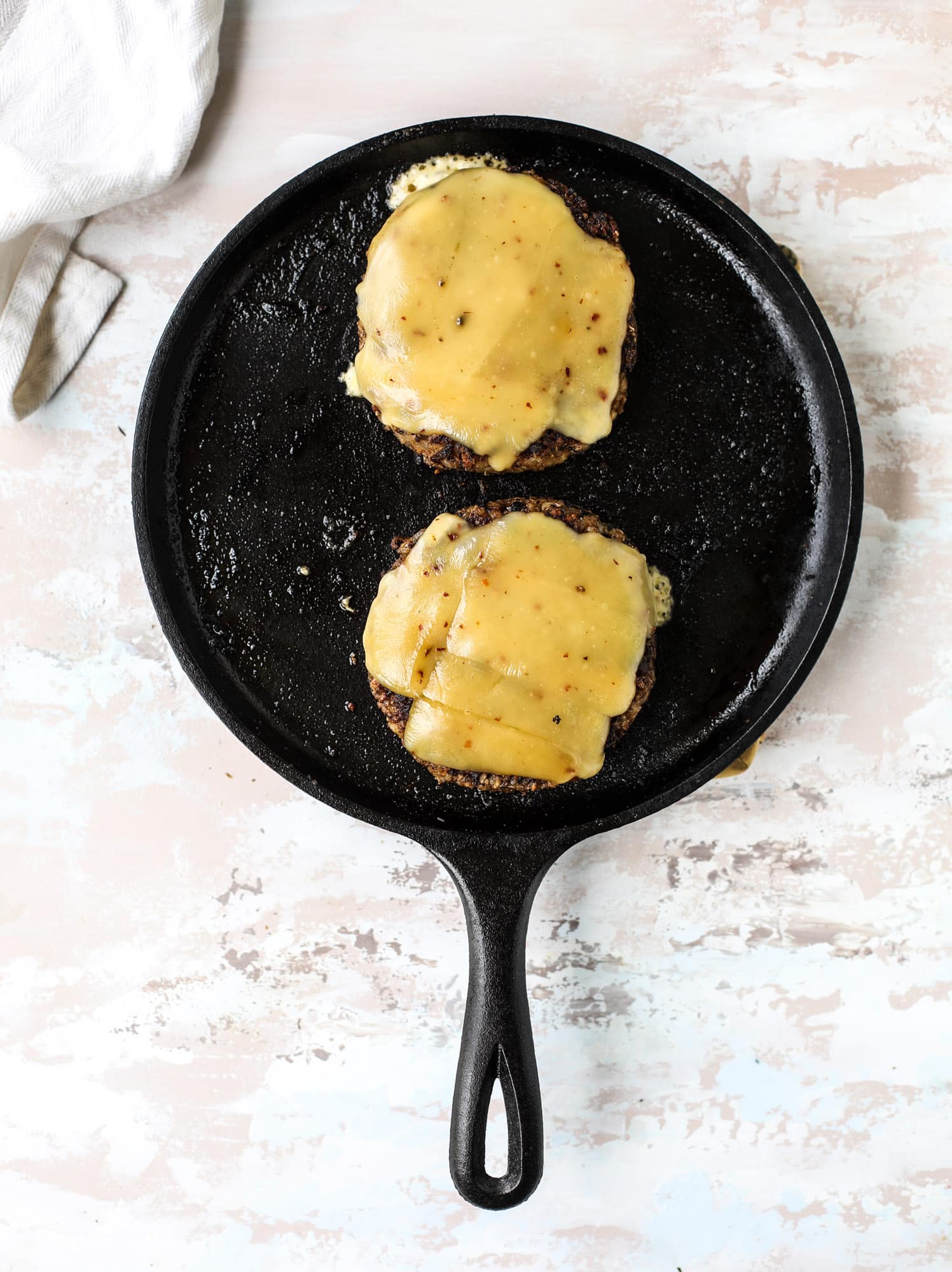 This is the best ever veggie burger and that is not an exaggeration! It's delicious, full of texture and chew, super satisfying and actually sticks together in the pan. You can serve it on buns, make a patty melt, a salad or lettuce wraps - perfection! I howsweeteats.com #best #veggie #burger #vegetarian #beans #quinoa
