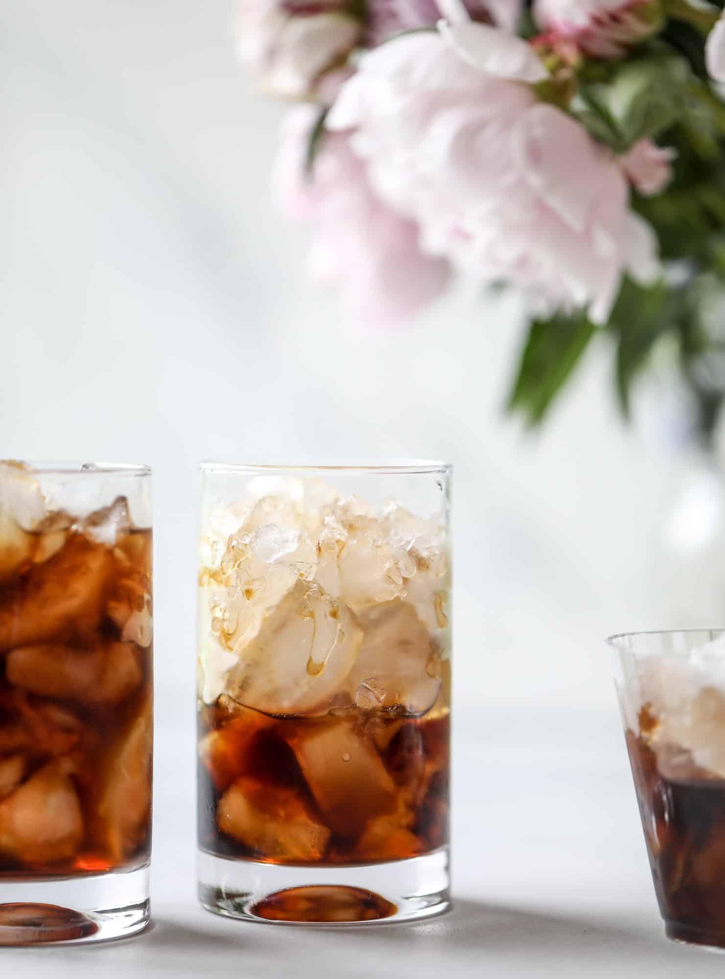This iced coffee soda is so perfect for summer! Rich coconut syrup, cold brew coffee, cream (or coconut cream!) if you'd like it and lots of bubbly soda. Tastes refreshing, feels like a cocktail and still gives you a pick-me-up! I howsweeteats.com #iced #coffee #soda #coconut