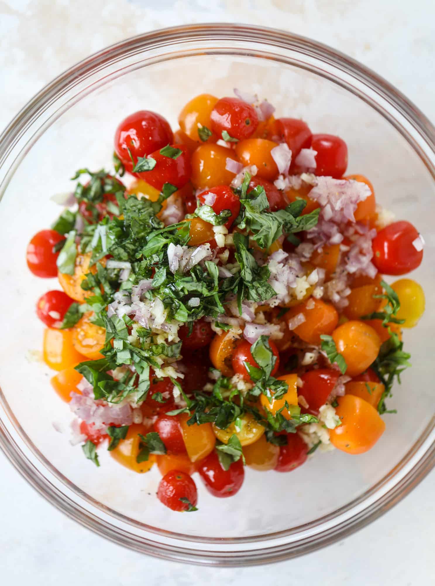 This bruschetta chicken is the perfect summer garden meal! Juicy, flavorful chicken topped with fresh tomatoes, garlic, basil and balsamic glaze, along with a touch of cheese. Served with pasta, it's an incredible meal. I howsweeteats.com #bruschetta #chicken #pasta #tomatoes #basil 