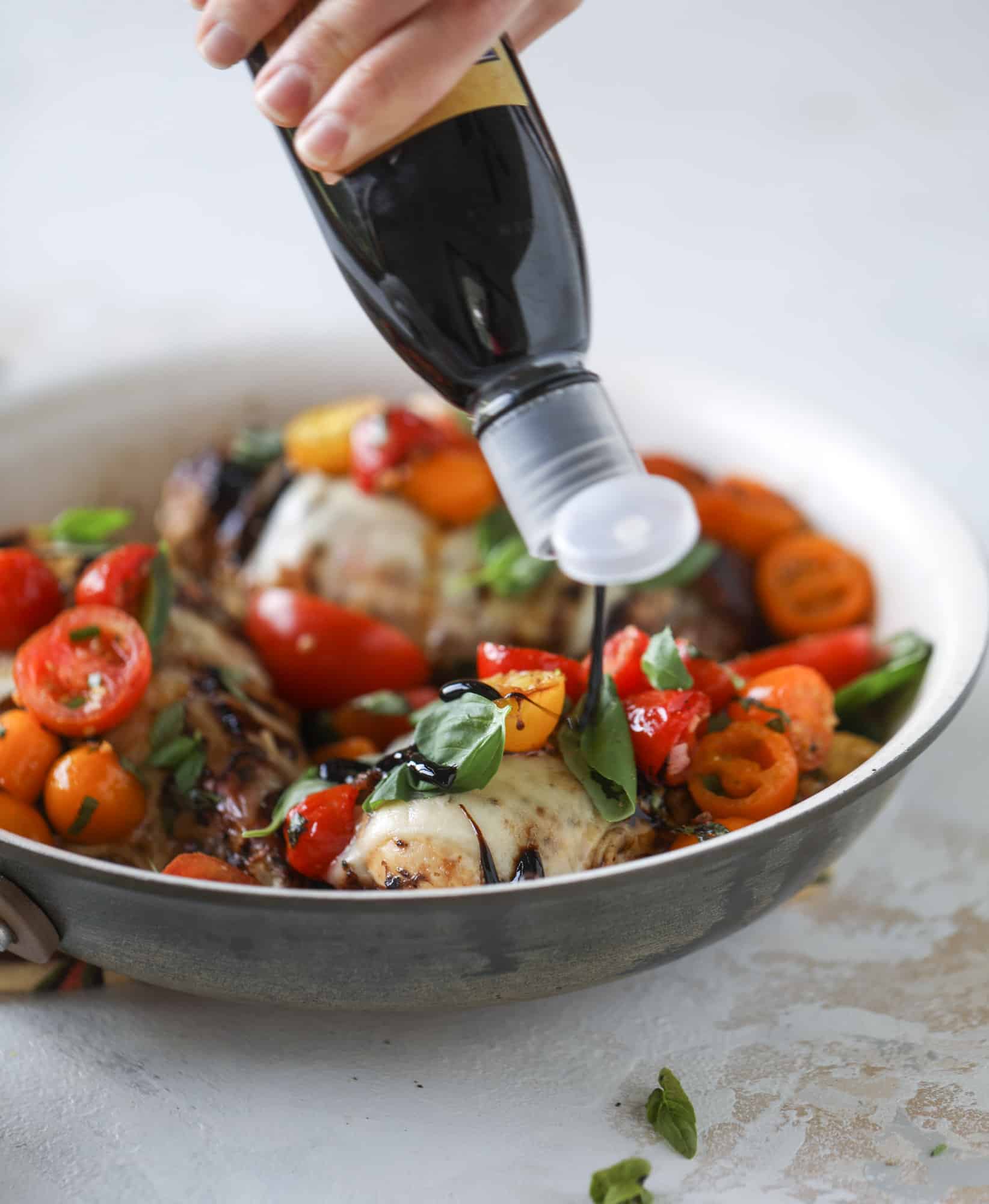 This bruschetta chicken is the perfect summer garden meal! Juicy, flavorful chicken topped with fresh tomatoes, garlic, basil and balsamic glaze, along with a touch of cheese. Served with pasta, it's an incredible meal. I howsweeteats.com #bruschetta #chicken #pasta #tomatoes #basil 