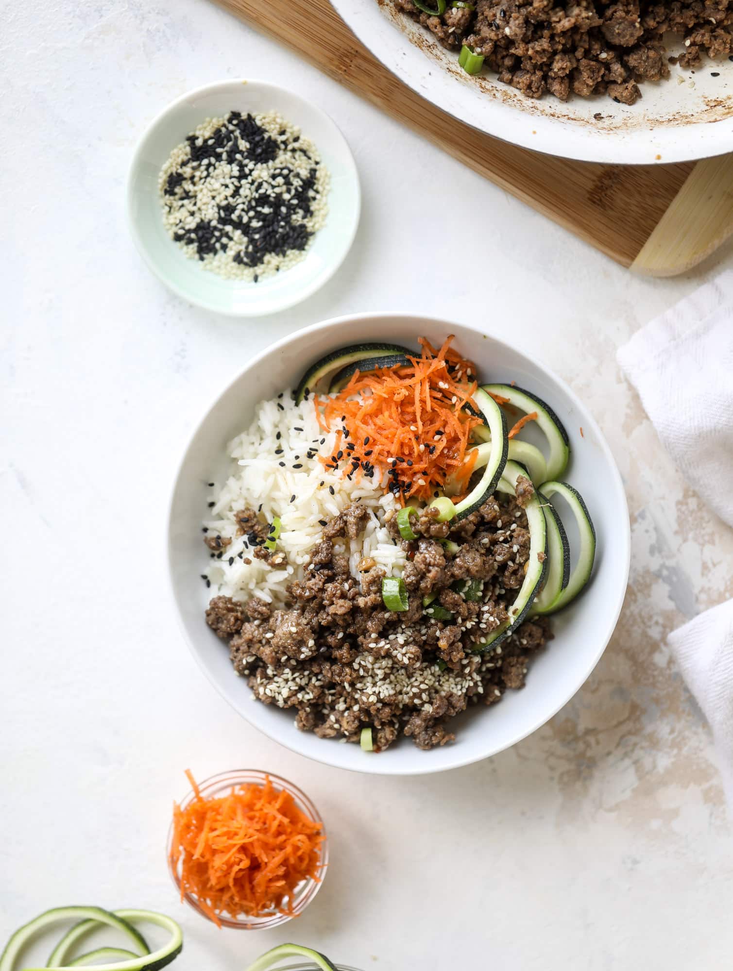 These korean beef bowls are so packed full of flavor that you won't want to eat anything else! Serve the beef with zucchini noodles, grated carrot and jasmine rice for a satisfying, flavor-packed bowl that comes together easily and quick! I howsweeteats.com #korean #beef