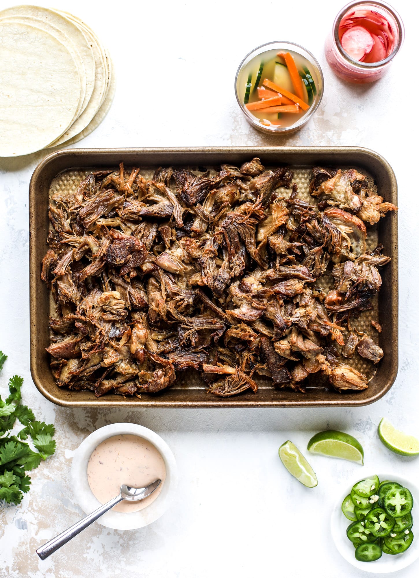 These bahn mi tacos are the perfect twist on the classic sandwich! Juicy pulled pork, pickled veggies, a tangy crema and loads of flavor. Bahn mi tacos are a delish weeknight meal or also work great if you have pork leftovers! I howsweeteats.com #bahn #mi #tacos #pork #dinner