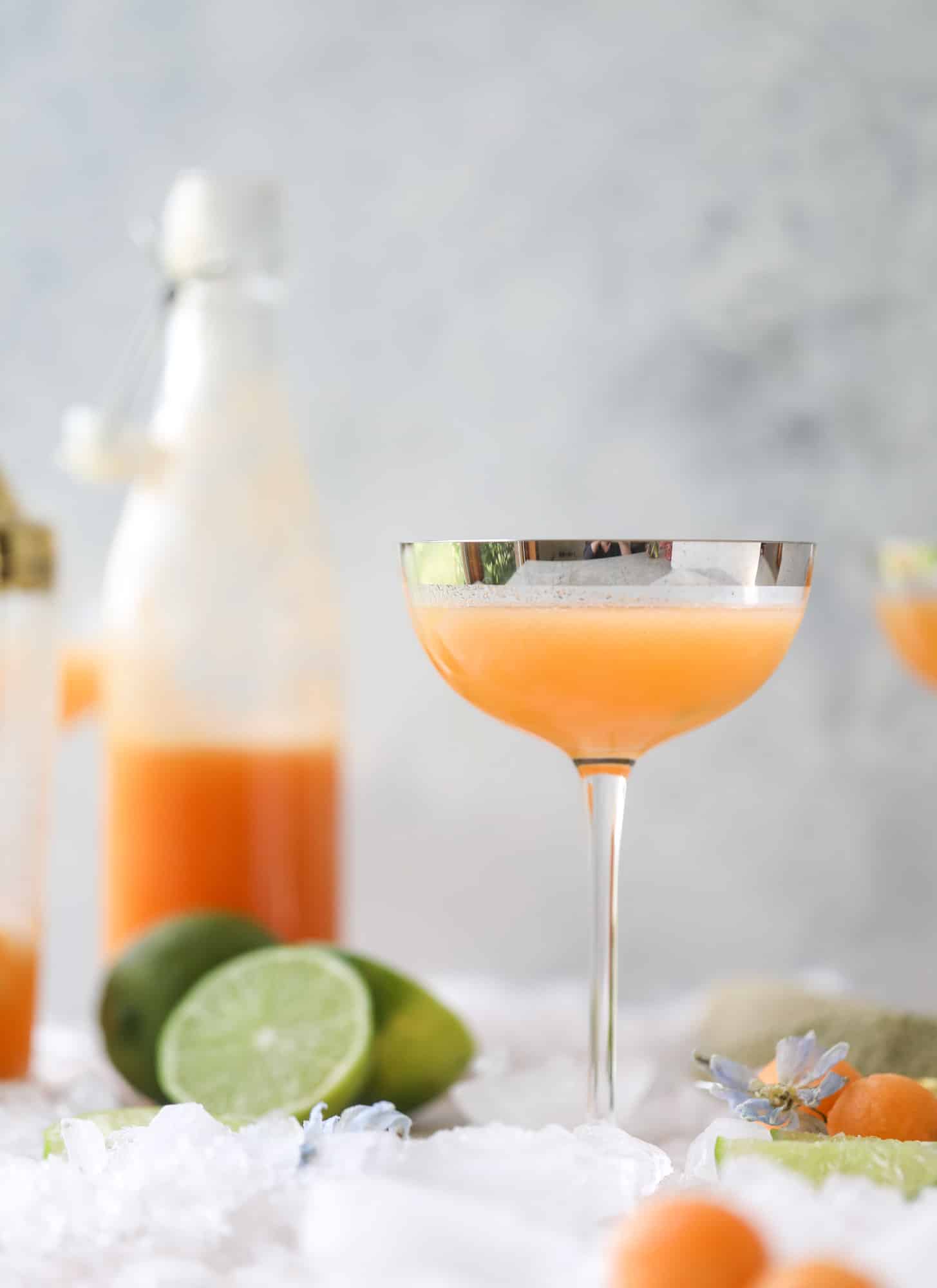 This cantaloupe daiquiri is the perfect way to celebrate summer! Freshly juiced melon, lime juice, rum and maraschino cherries - it's refreshing and cool and a fantastic cocktail to have during happy hour! Isn't the color amazing too?! I howsweeteats.com #cantaloupe #cocktail #daiquiri #lime #rum #summer