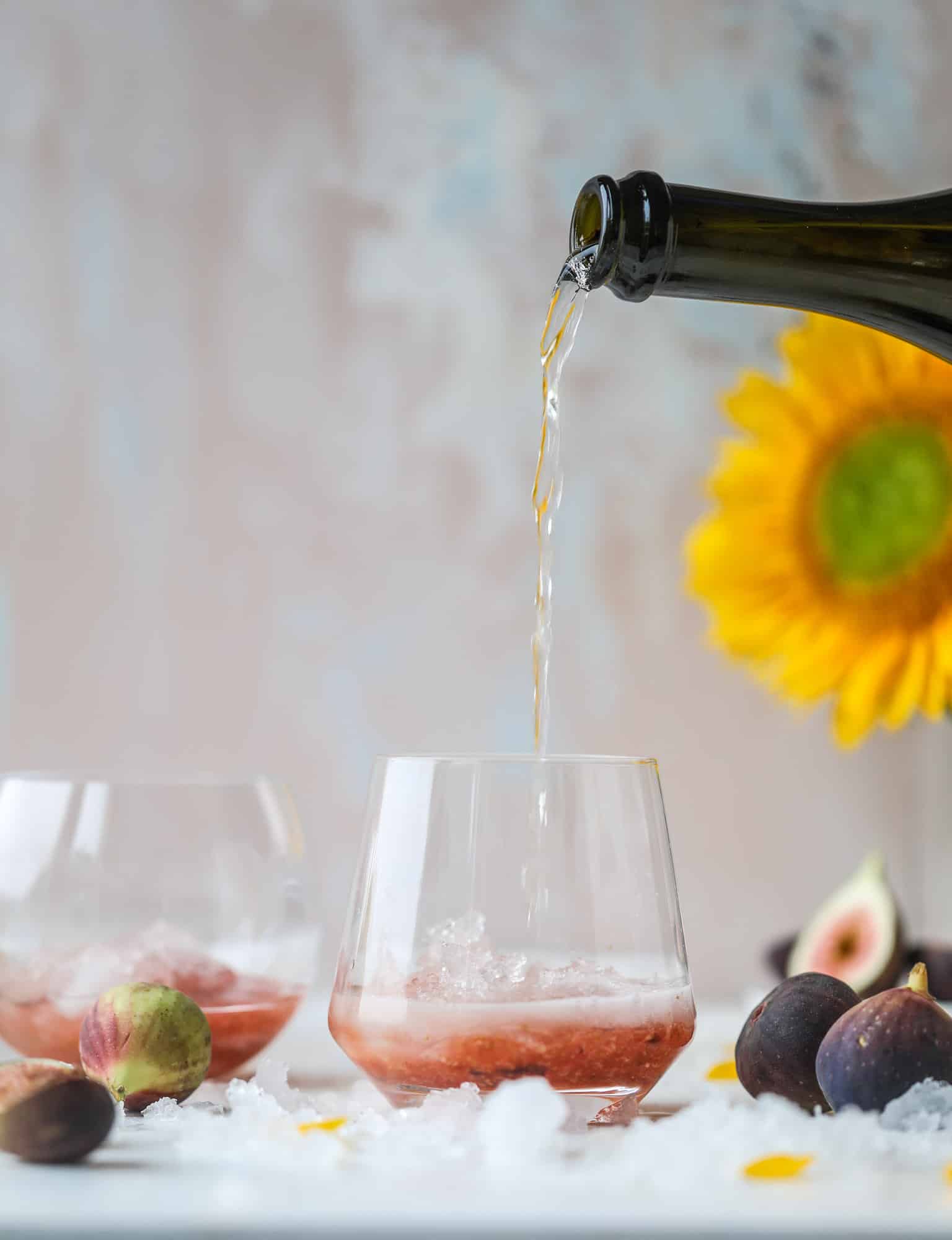 This new fig cocktail is so delicious and perfect for your fresh juicy figs! Muddle the fresh figs with brown sugar and a touch of lemon, then add them to a glass with crushed ice and pour some bubbly on top. I love Prosecco, but you can use a sweeter bubbly too! I howsweeteats.com #fig #cocktail #brown #sugar #prosecco