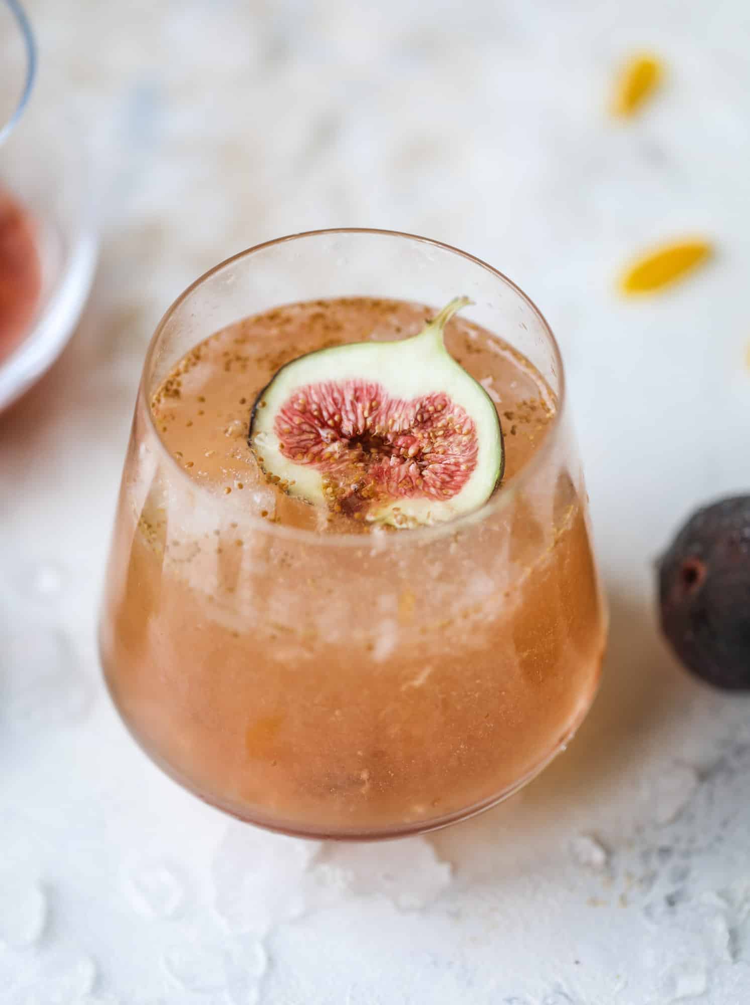 This new fig cocktail is so delicious and perfect for your fresh juicy figs! Muddle the fresh figs with brown sugar and a touch of lemon, then add them to a glass with crushed ice and pour some bubbly on top. I love Prosecco, but you can use a sweeter bubbly too! I howsweeteats.com #fig #cocktail #brown #sugar #prosecco