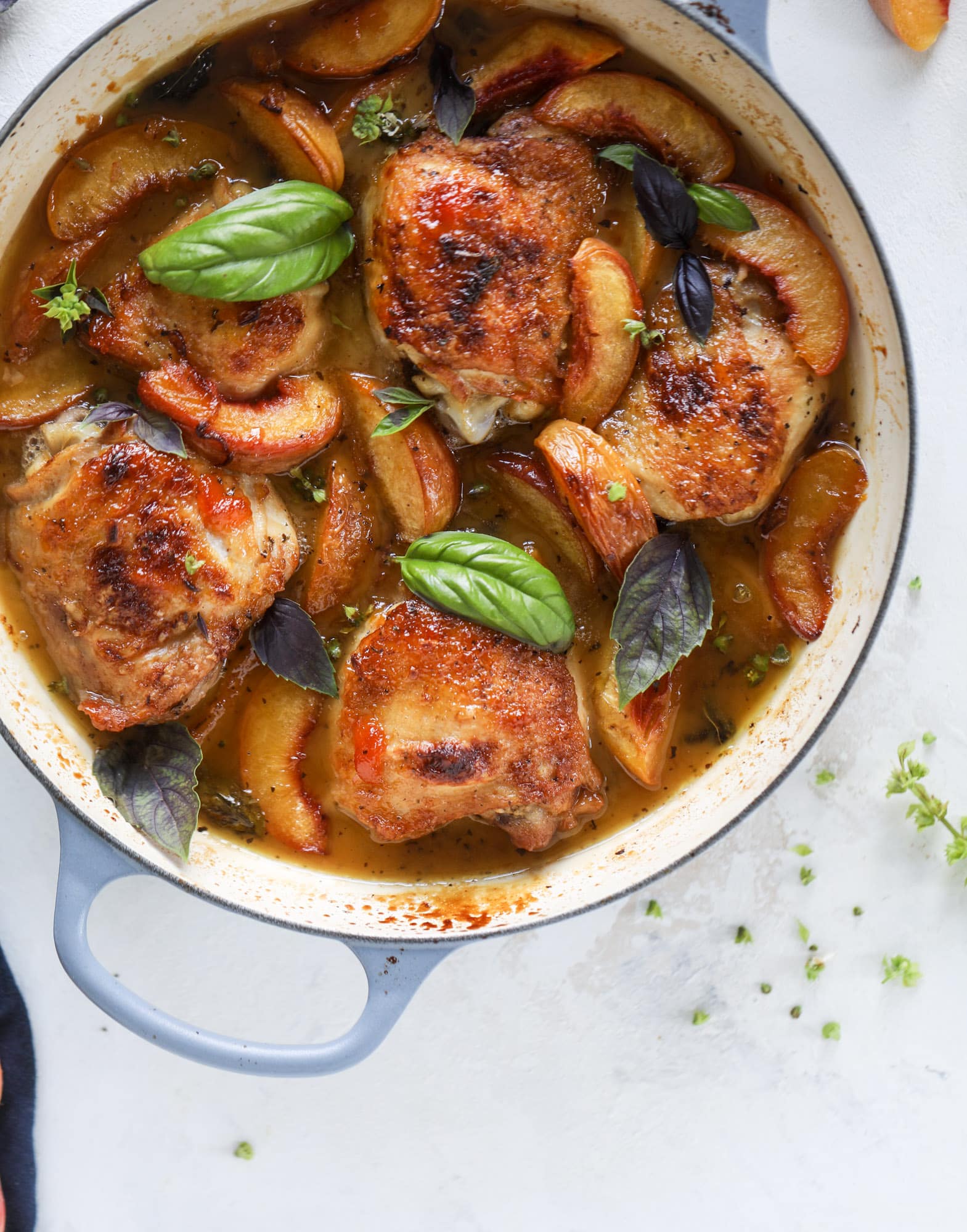This amazing summertime one pot chicken is made with fresh peaches and basil and takes no time at all. The sweet and savory combination is perfect for a quick weeknight meal; the sauce is amazing for dipping and the chicken is flavorful as can be. I howsweeteats.com #chicken #peach #basil #easy #dinner #recipe #summer #healthy