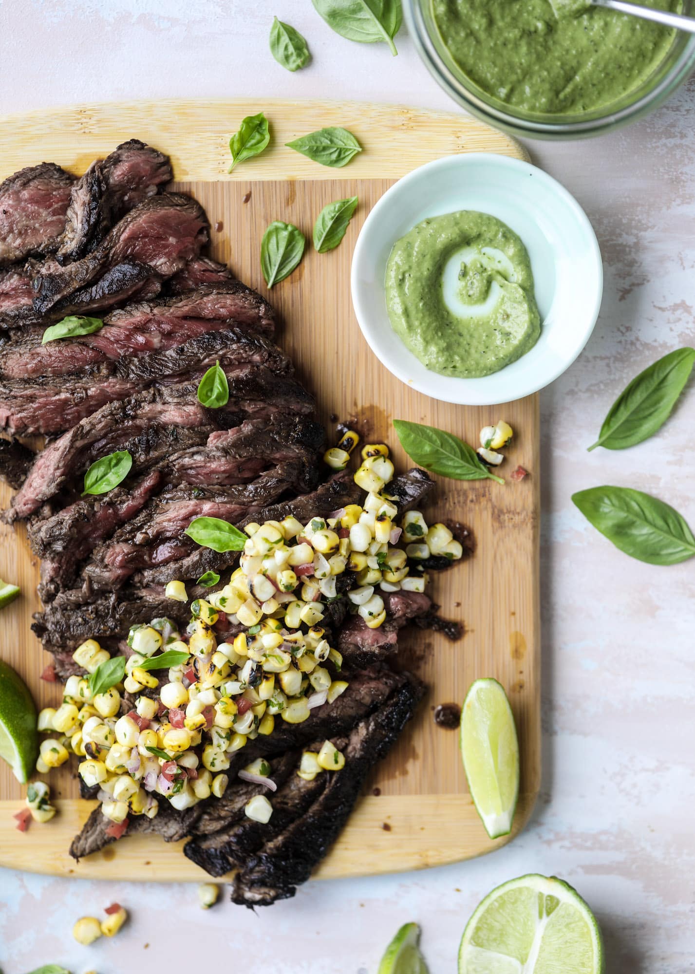 This skirt steak recipe is so super easy and delicious! Marinate it for a bit, prepare it to your liking then serve it with the most flavorful avocado pesto and grilled corn relish. Feels like a fancy restaurant meal and will make you love skirt steak forever! I howsweeteats.com #skirt #steak #avocado #pesto #corn #relish #recipes