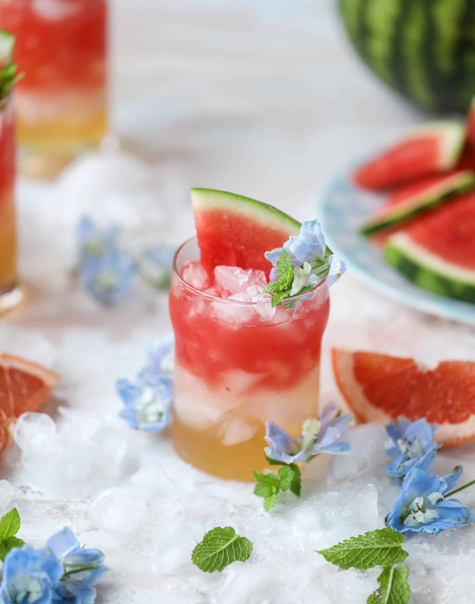 This watermelon grapefruit paloma cocktail is a summertime dream! Grapefruit syrup is super easy to make and when it's combined with fresh watermelon juice and tequila... oooh! Best happy hour ever. I howsweeteats.com #grapefruit #watermelon #paloma #cocktail #tequila
