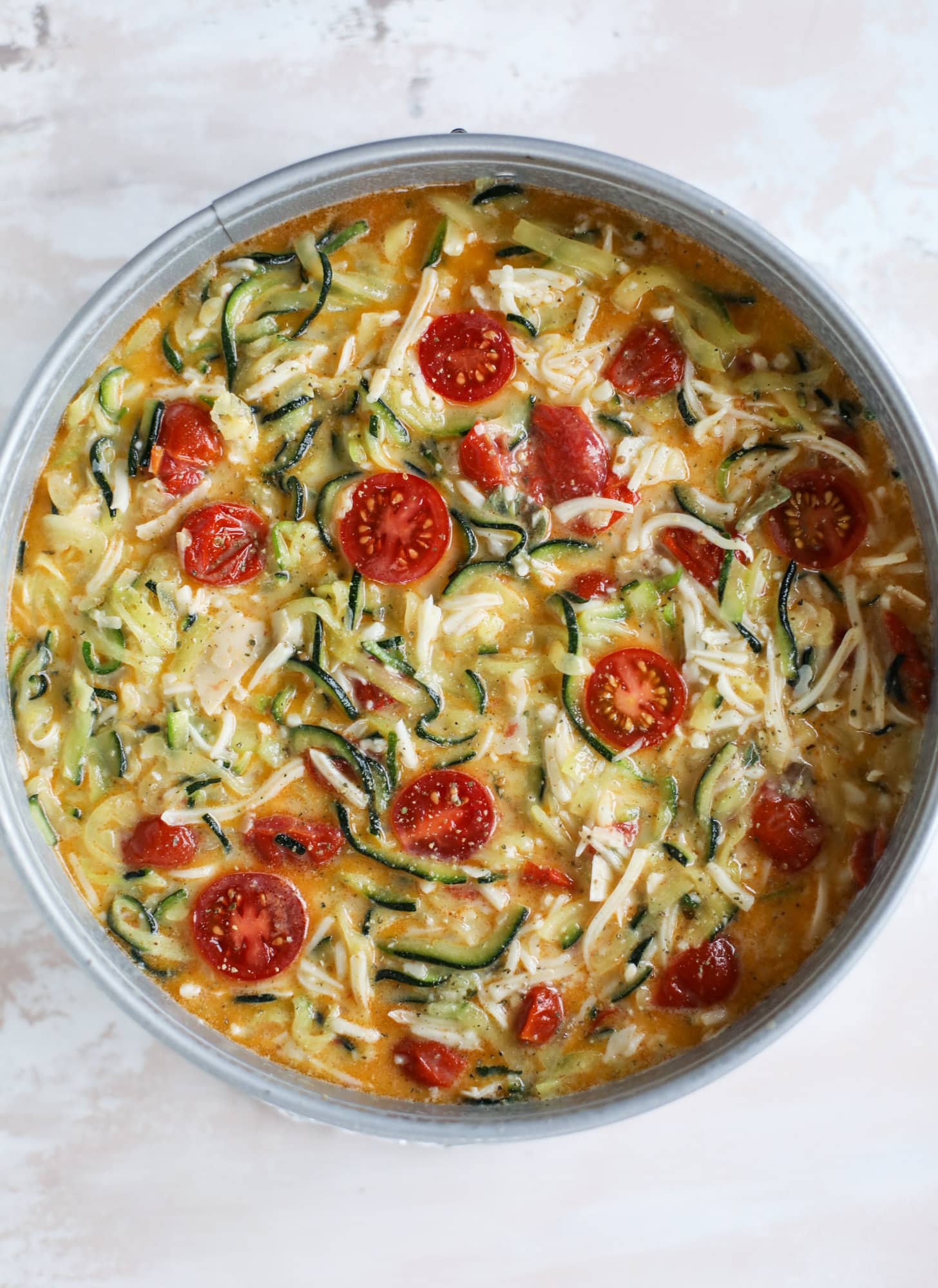 This zucchini pie recipes is absolutely divine and perfect for breakfast or dinner! Completely with garlic and blistered tomatoes, it combines cheese and egg to make a to-die-for frittata-like dish that can be eaten hot or cold! I howsweeteats.com #zucchini #pie #tomatoes #eggs #recipes #garden #summer