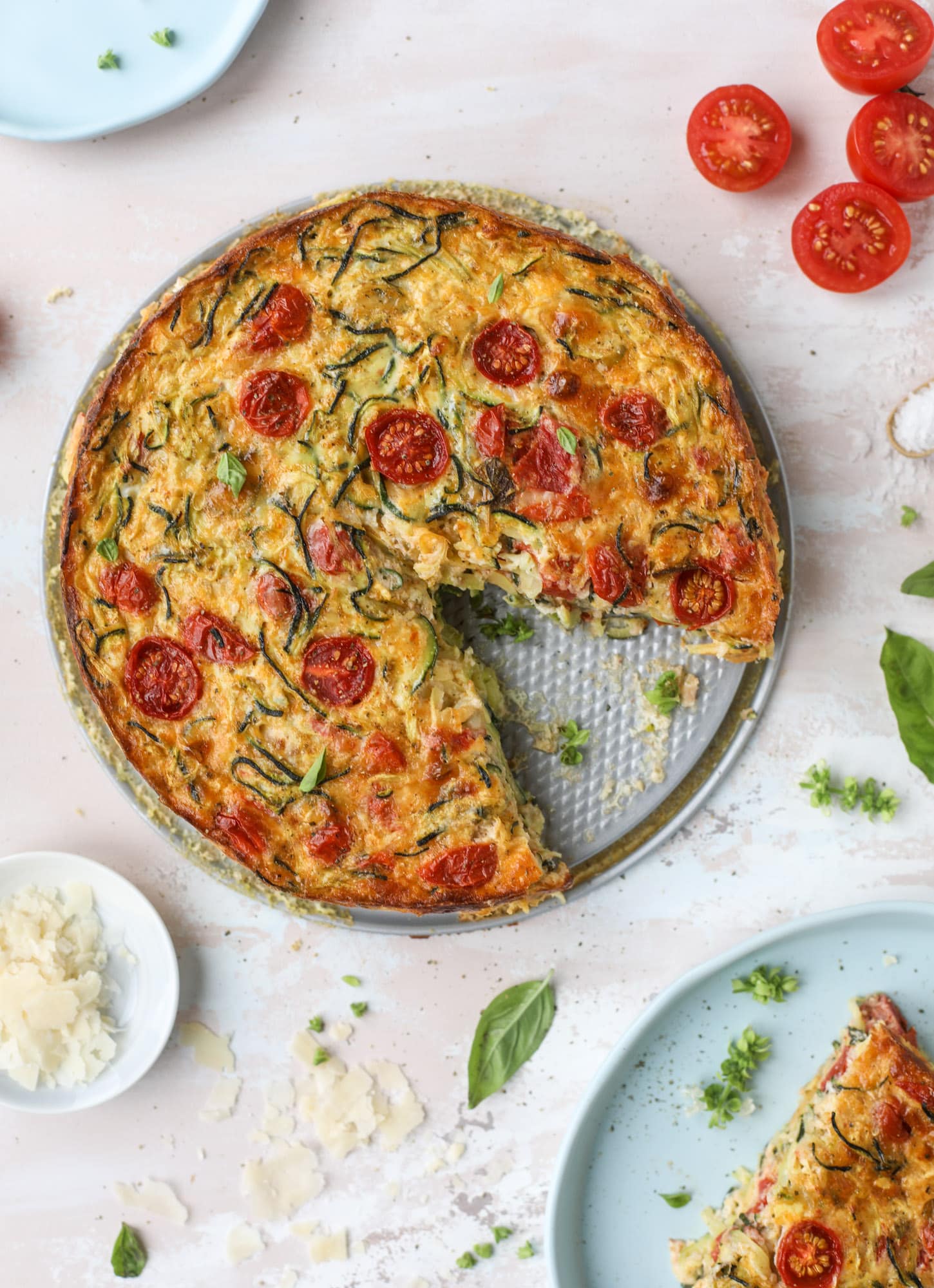 This zucchini pie recipes is absolutely divine and perfect for breakfast or dinner! Completely with garlic and blistered tomatoes, it combines cheese and egg to make a to-die-for frittata-like dish that can be eaten hot or cold! I howsweeteats.com #zucchini #pie #tomatoes #eggs #recipes #garden #summer