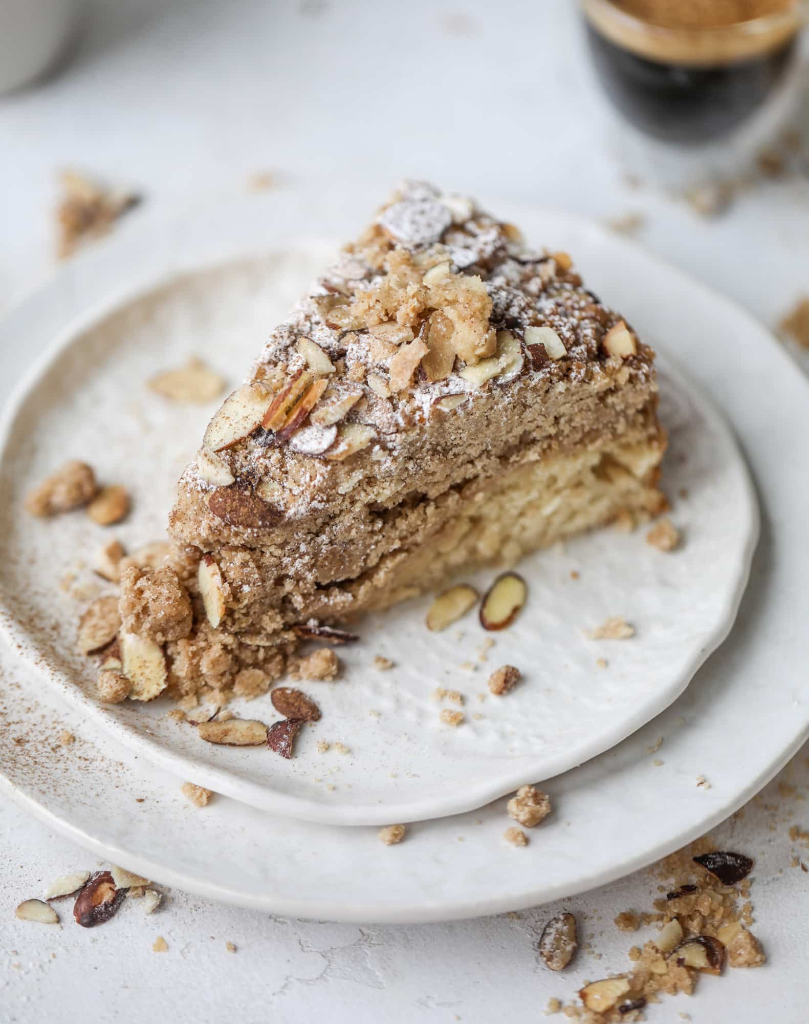 This almond crumb cake is so delicious and perfect for breakfast or dessert! It's full of delicious almond flavor and crunch and the crumb on top is so thick and perfect. It's like an almond croissant on steroids. I howsweeteats.com #almond #crumb #cake