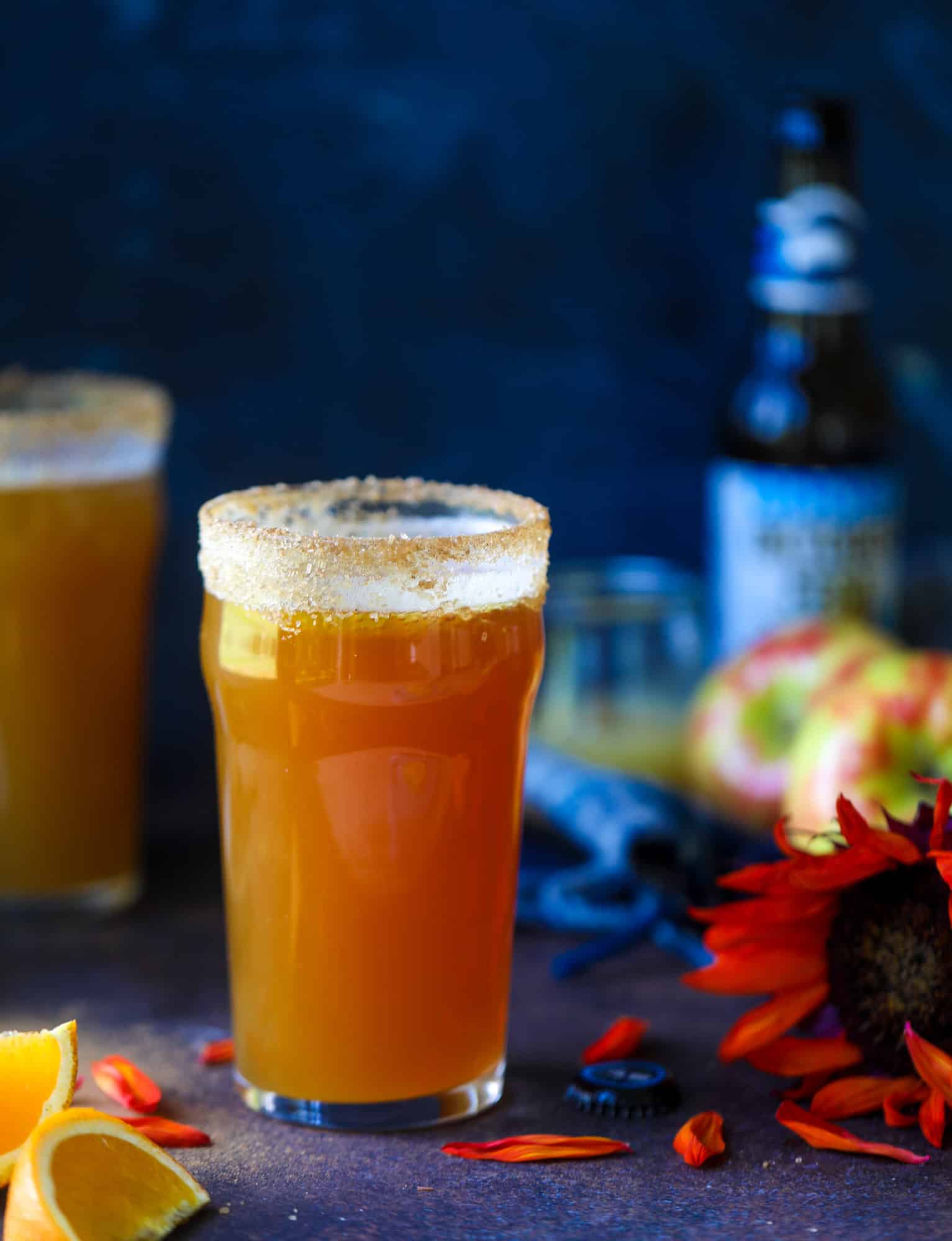 This apple cider shandy recipes is perfect for the fall season! Apple cider, sparkling cider and your favorite beer come together in an icy glass to create the best flavor ever. Finished with a cinnamon sugar rim, there's nothing better! I howsweeteats.com #apple #cider #shandy #cocktails #beer