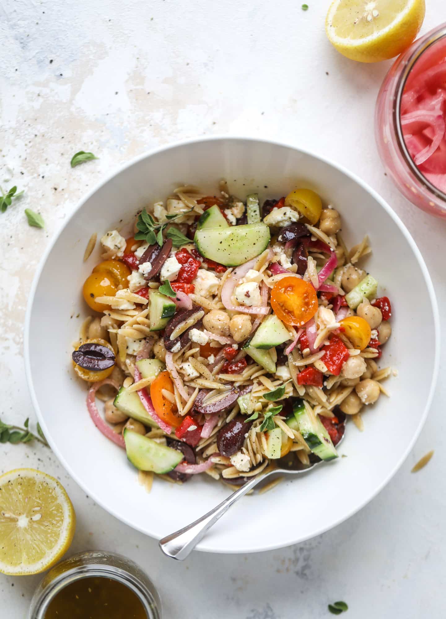 This incredible greek orzo salad in a jar is to die for! The recipe is so easy and flavorful, super satisfying and perfect for meal prep. This salad in a jar is a delicious lunch idea for the weekdays and keeps you feeling full and happy! I howsweeteats.com #salad #jar #greek #orzo #recipes #healthy #lunch #mealprep
