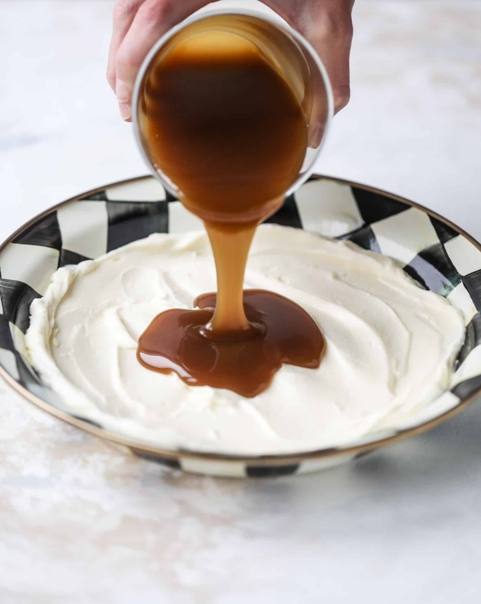 This caramel apple dip is my take on the old-school cream cheese based dip that is super delicious! Here, we have a mascarpone base with a bourbon caramel sauce, topped with roasted chopped cashews. Just add apples! I howsweeteats.com #caramel #apple #dip #appetizer #snack