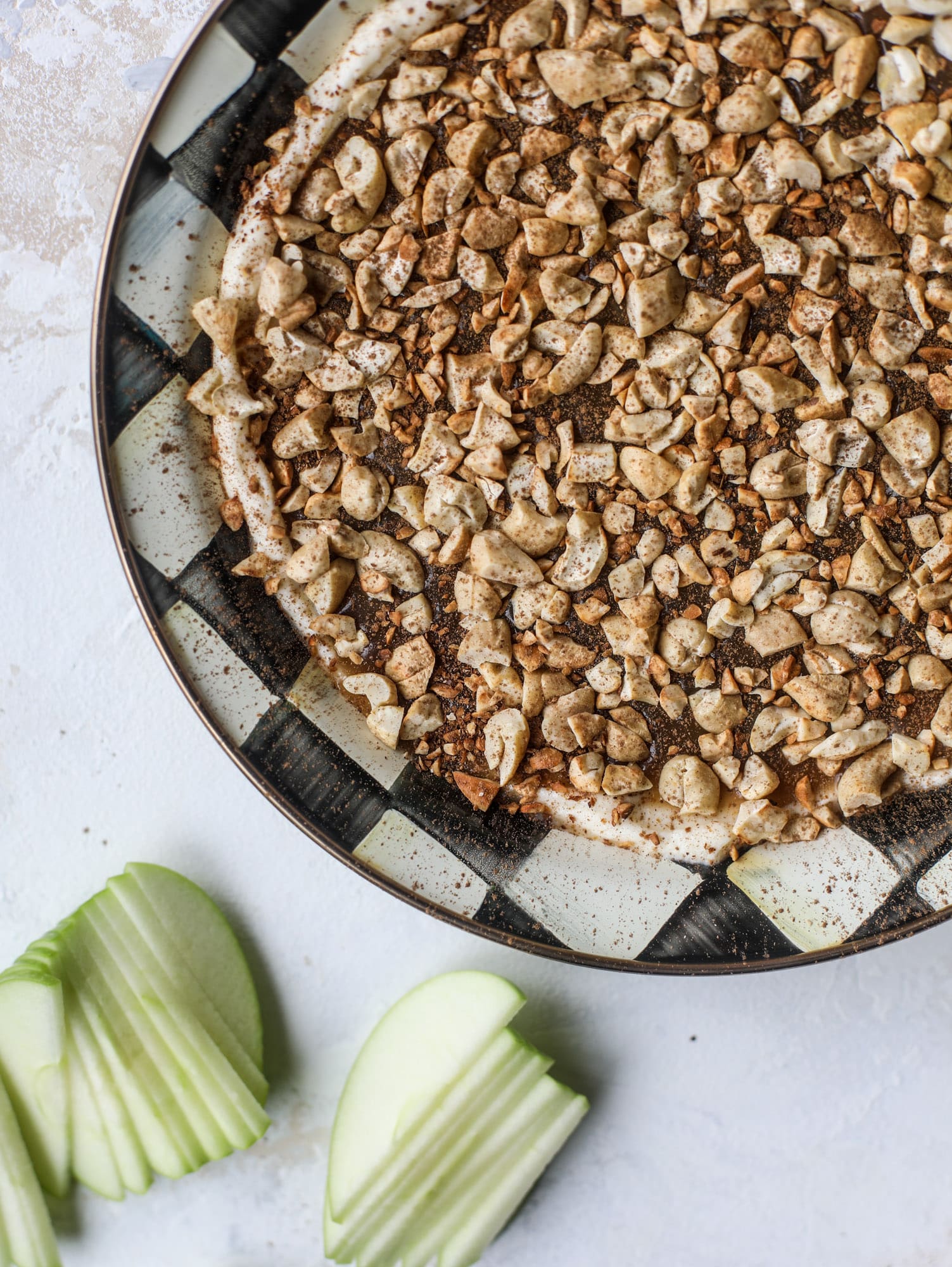 This caramel apple dip is my take on the old-school cream cheese based dip that is super delicious! Here, we have a mascarpone base with a bourbon caramel sauce, topped with roasted chopped cashews. Just add apples! I howsweeteats.com #caramel #apple #dip #appetizer #snack