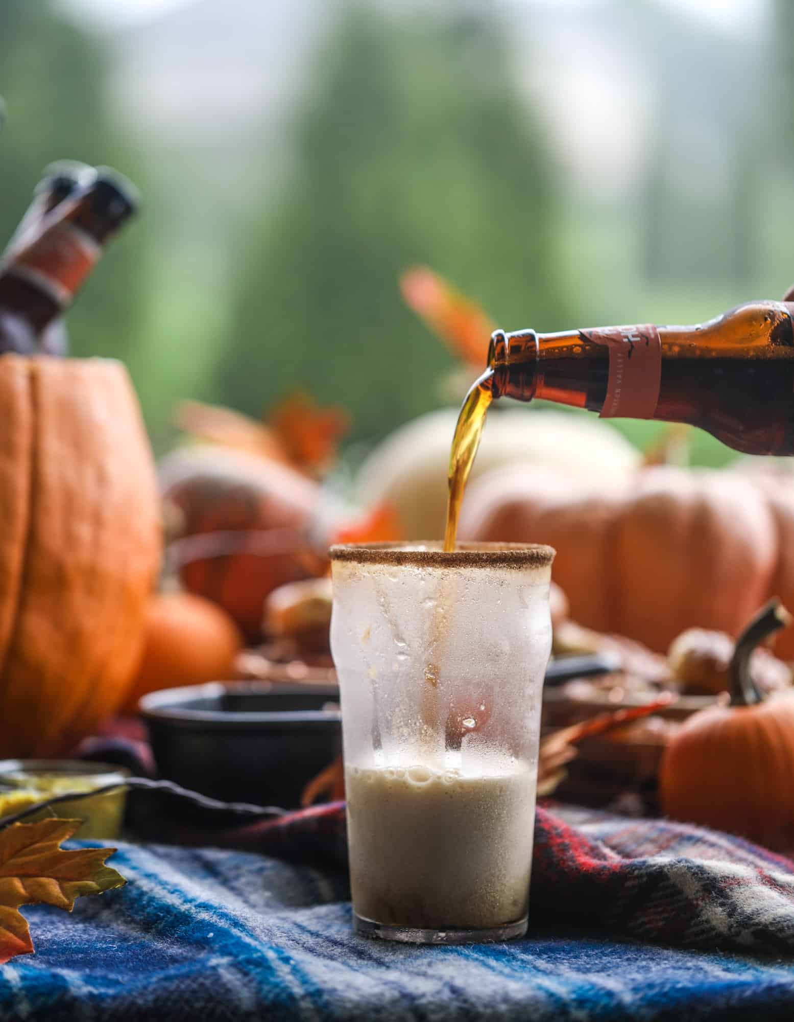 This is the cutest way ever to serve the best pumpkin beer! If you do a pumpkin beer party of a pumpkin beer tasting, this pumpkin cooler is an adorable (and easy!) way to make things festive. Kick it up with a hot pretzel bar and lots of dipping sauce too! I howsweeteats.com #pumpkin #beer #cooler #softpretzel #fall #cheese