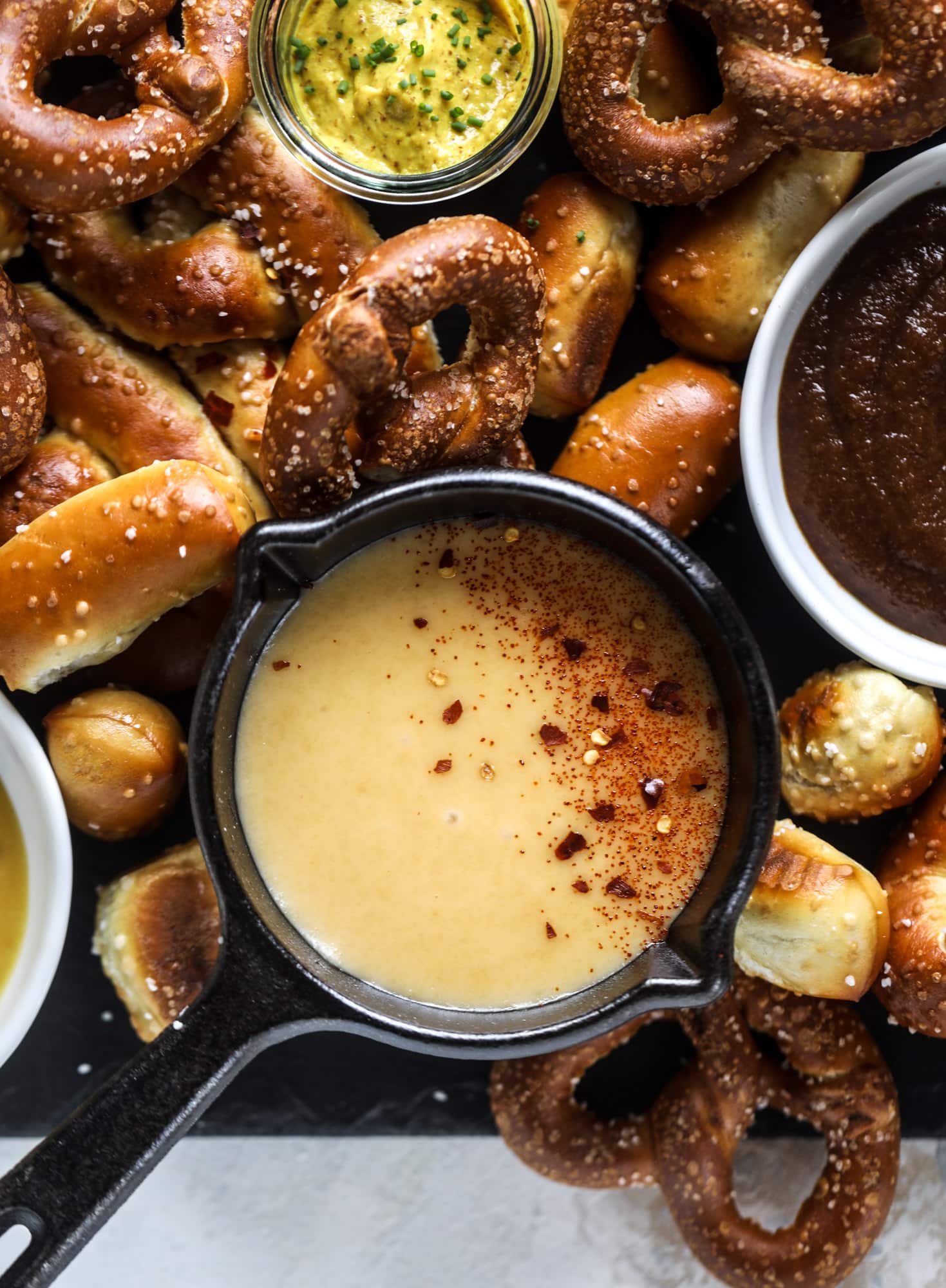 This is the cutest way ever to serve the best pumpkin beer! If you do a pumpkin beer party of a pumpkin beer tasting, this pumpkin cooler is an adorable (and easy!) way to make things festive. Kick it up with a hot pretzel bar and lots of dipping sauce too! I howsweeteats.com #pumpkin #beer #cooler #softpretzel #fall #cheese