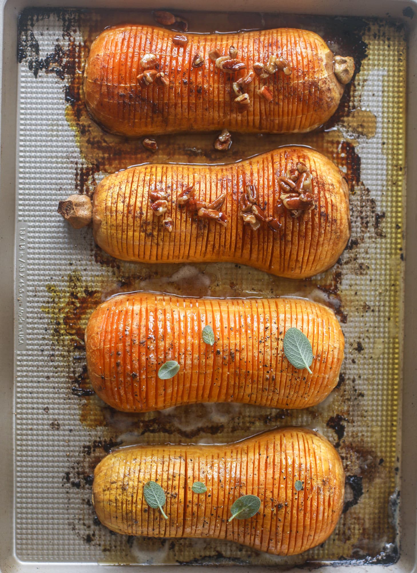 This hasselback butternut squash is perfect for Thanksgiving - and you can easily make it two ways! We have a maple pecan hassleback butternut squash and a brown butter sage hasselback butternut squash. Delicious! I howsweeteats.com #hasselback #butternutsquash