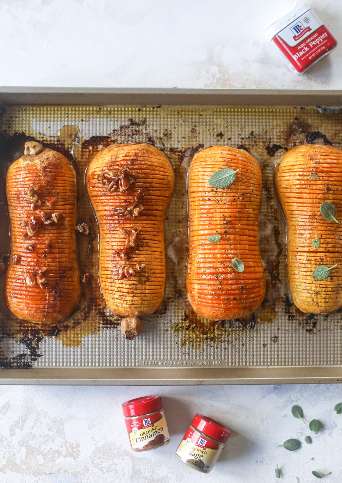 This hasselback butternut squash is perfect for Thanksgiving - and you can easily make it two ways! We have a maple pecan hassleback butternut squash and a brown butter sage hasselback butternut squash. Delicious! I howsweeteats.com #hasselback #butternutsquash