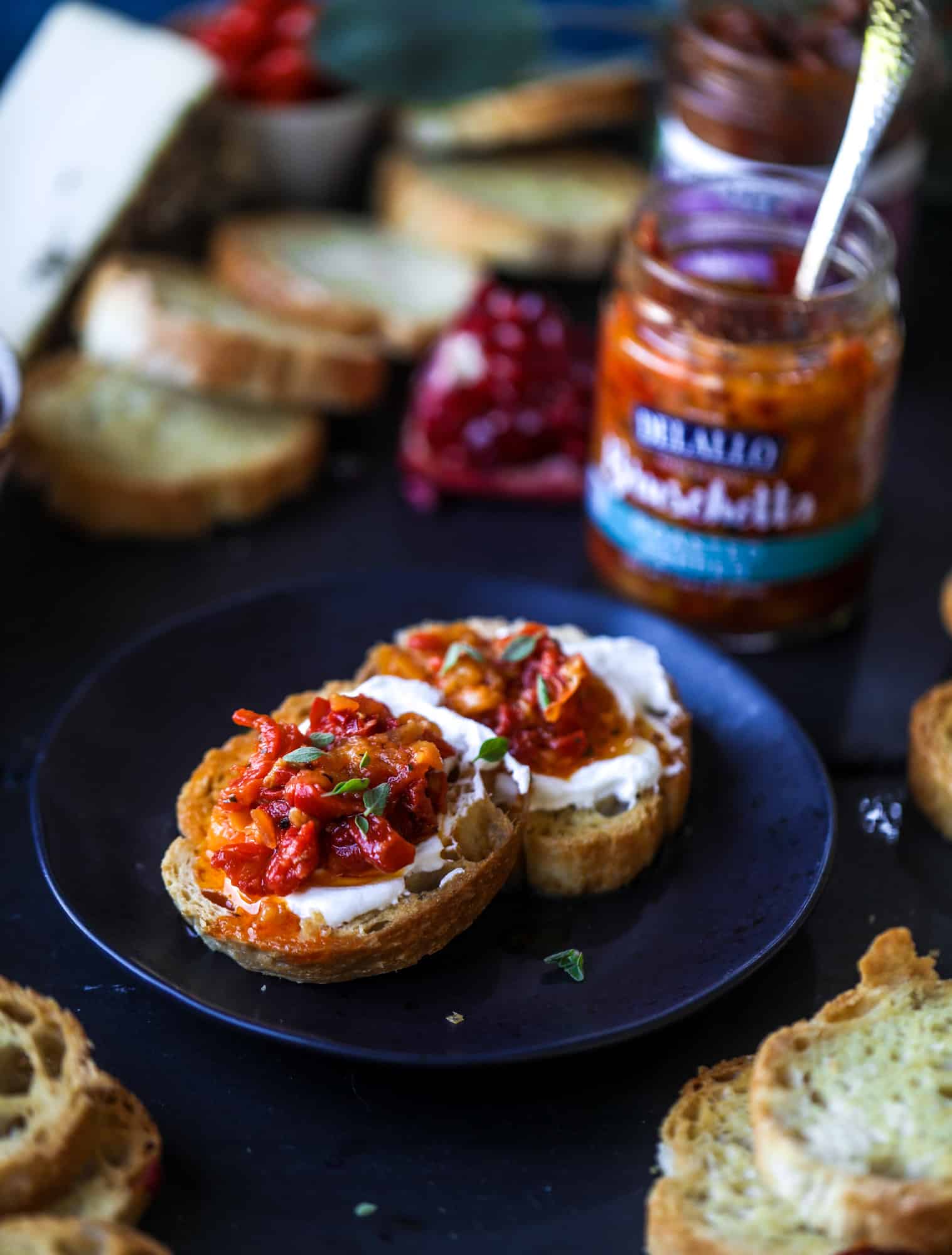 This is the perfect autumn harvest bruschetta board to feed a crowd or serve at a party! The standout is pomegranate relish with a cinnamon shallot vinaigrette, lots of toasty bread, bruschettas, cheese and olives. Everything that's delish! I howsweeteats.com #bruschetta #board