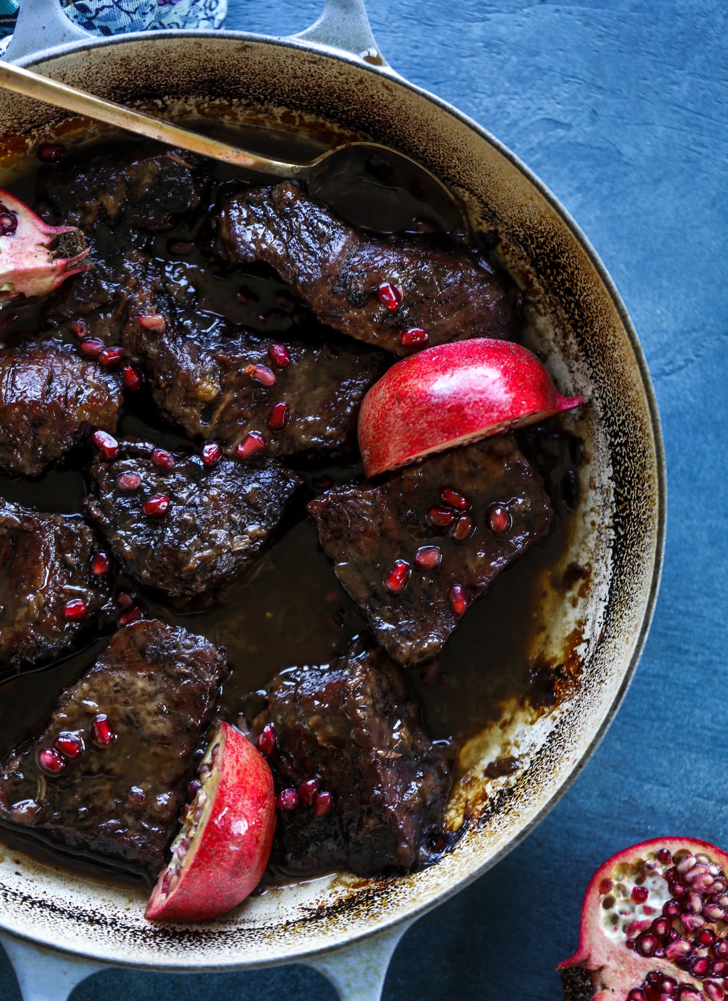 These pomegranate braised short ribs are an incredible take on comfort food! Pomegranate juice and molasses are the base of the recipe and after braising, you're left with tender, juicy and flavorful beef that is amazing served with polenta, potatoes or even in tacos. I howsweeteats.com #braised #shortribs