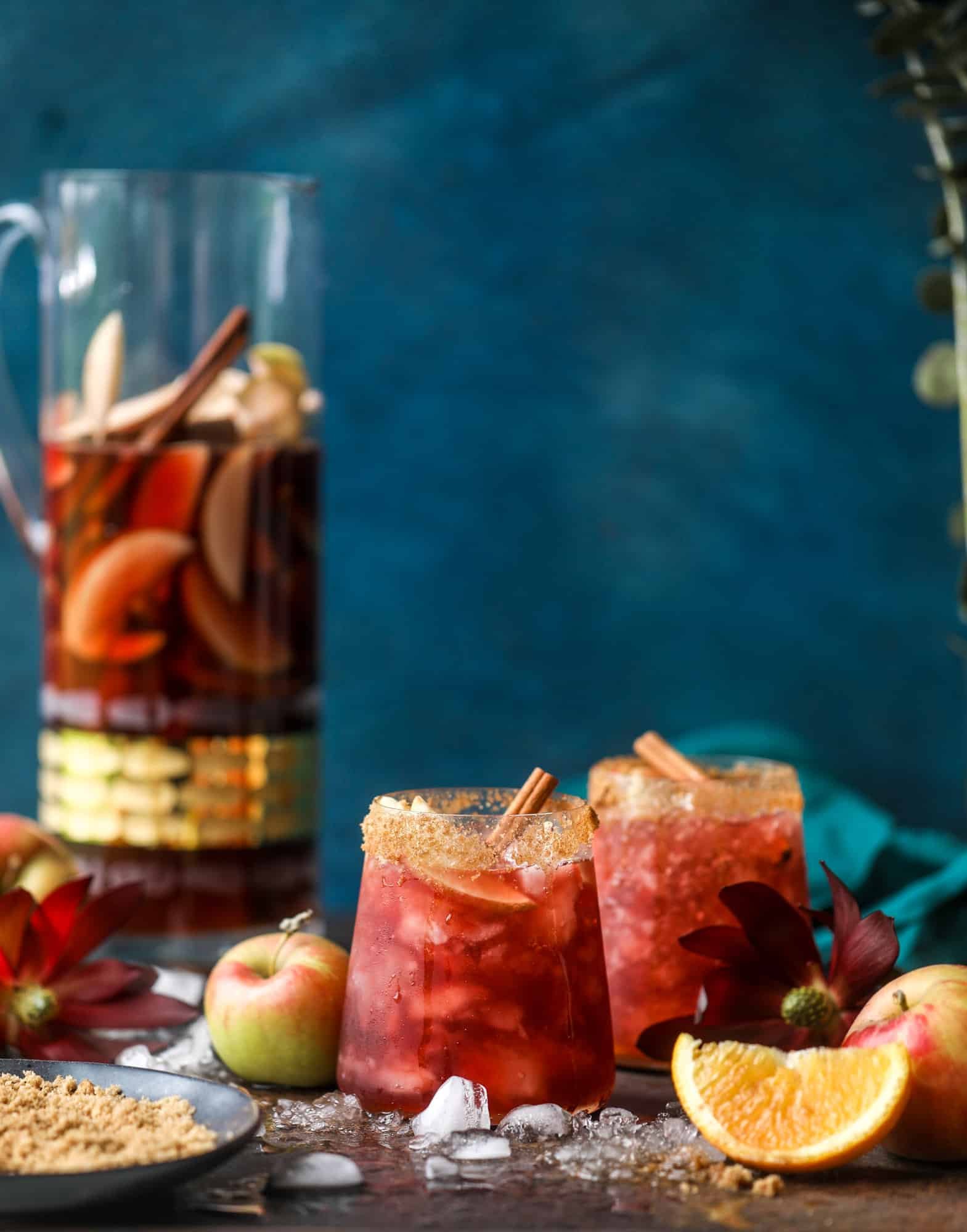 This red apple cider sangria will soon because a staple for your fall! It's delicious and not too sweet, with a base of red wine, apple cider and maple syrup. Cinnamon sticks and apple slices round out the pitcher and it's so flavorful and perfect for the season! I howsweeteats.com #red #apple #cider #sangria 