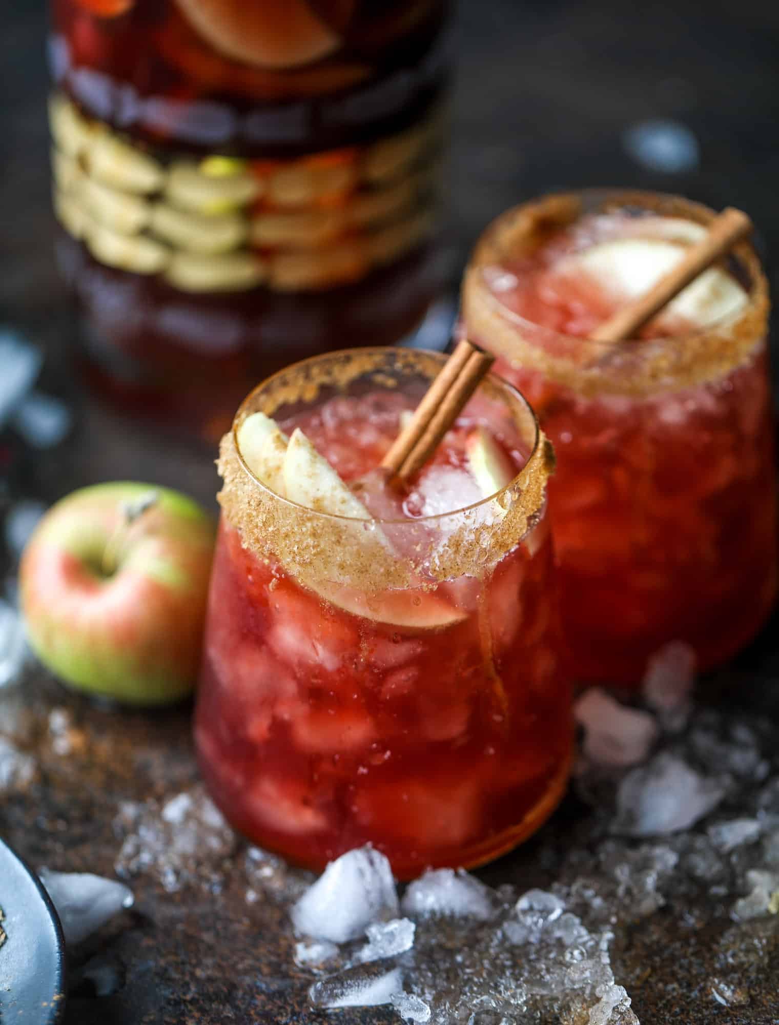 This red apple cider sangria will soon because a staple for your fall! It's delicious and not too sweet, with a base of red wine, apple cider and maple syrup. Cinnamon sticks and apple slices round out the pitcher and it's so flavorful and perfect for the season! I howsweeteats.com #red #apple #cider #sangria 
