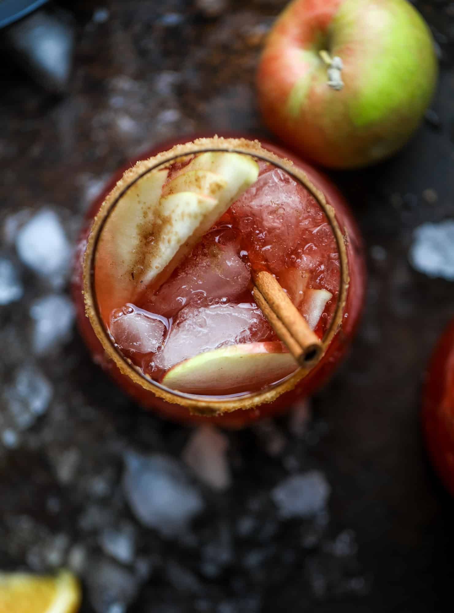 This red apple cider sangria will soon because a staple for your fall! It's delicious and not too sweet, with a base of red wine, apple cider and maple syrup. Cinnamon sticks and apple slices round out the pitcher and it's so flavorful and perfect for the season! I howsweeteats.com #red #apple #cider #sangria 