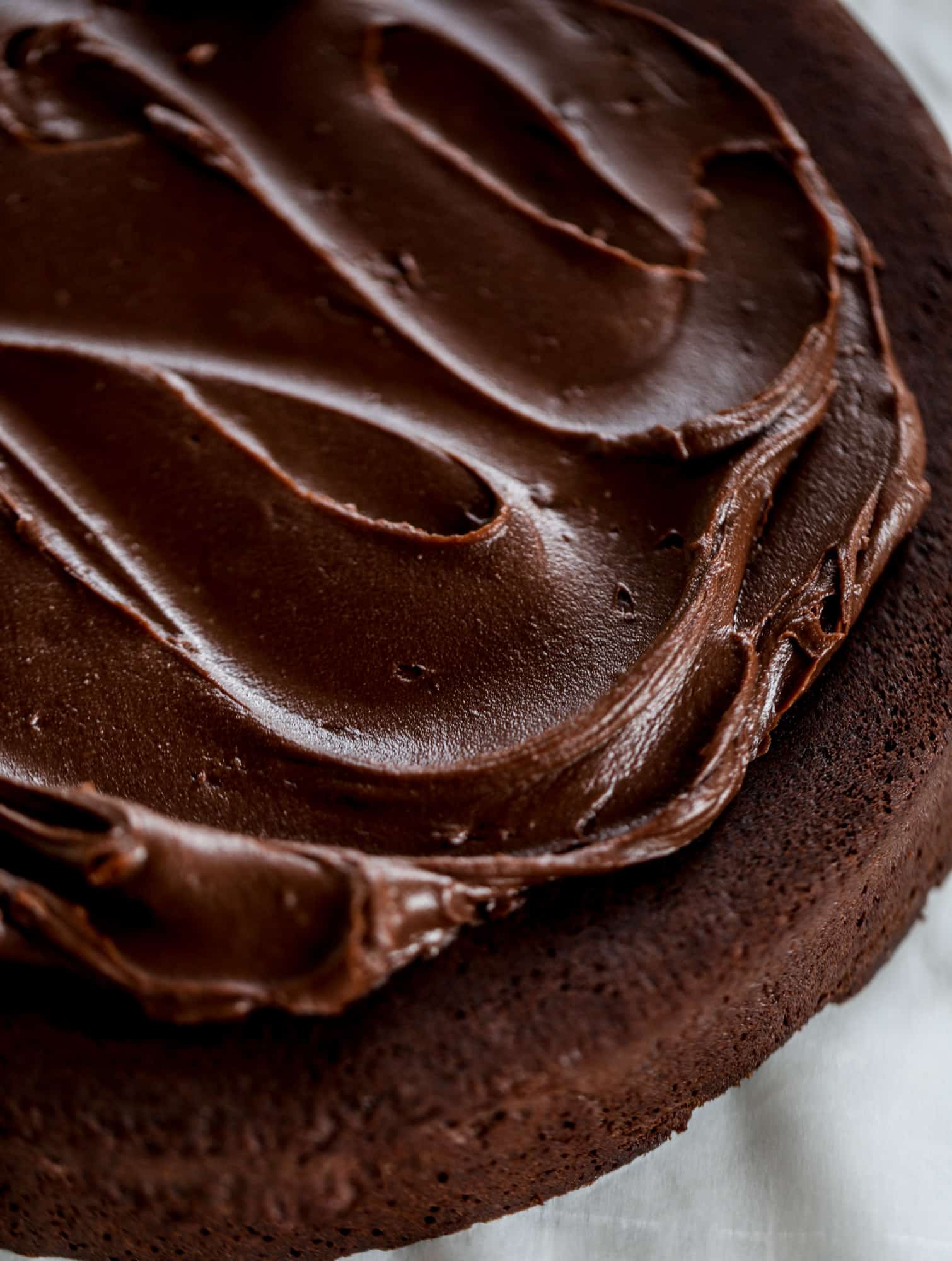 This salted dark chocolate stout cake is absolutely divine! It's ridiculously rich and perfect for a crowd or a party. Pumpkin stout batter is baked into fluffy laters and covered in a super fudgy chocolate ganache. Perfect for chocolate lovers! I howsweeteats.com #dark #chocolate #stout #cake #salted