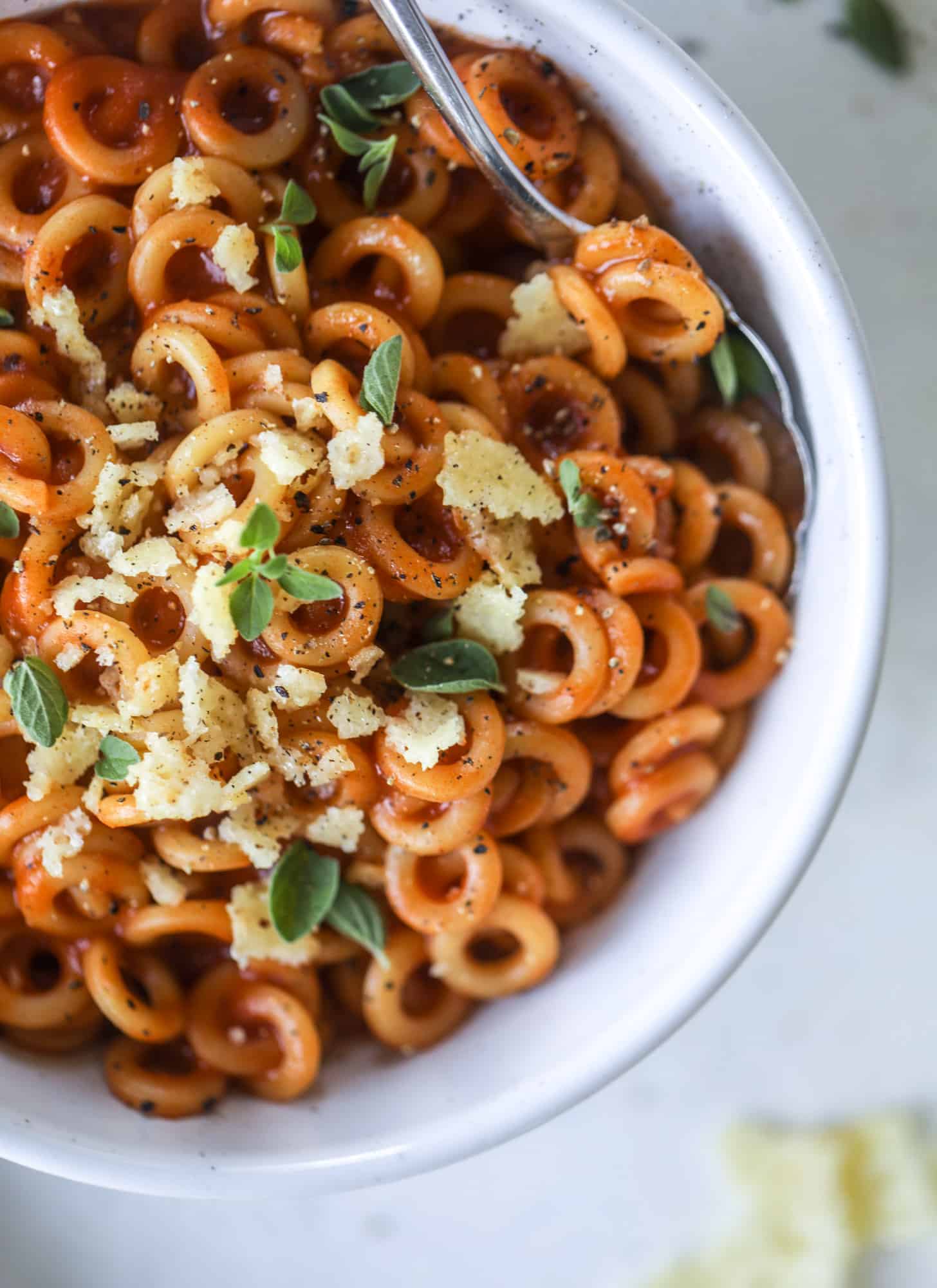 These homemade spaghettios are the ultimate comfort food! They come together in less than 30 minutes, are super easy and flavorful and topped with crispy crunchy manchego cheese that takes the taste over the top! I howsweeteats.com #homemade #spaghettios