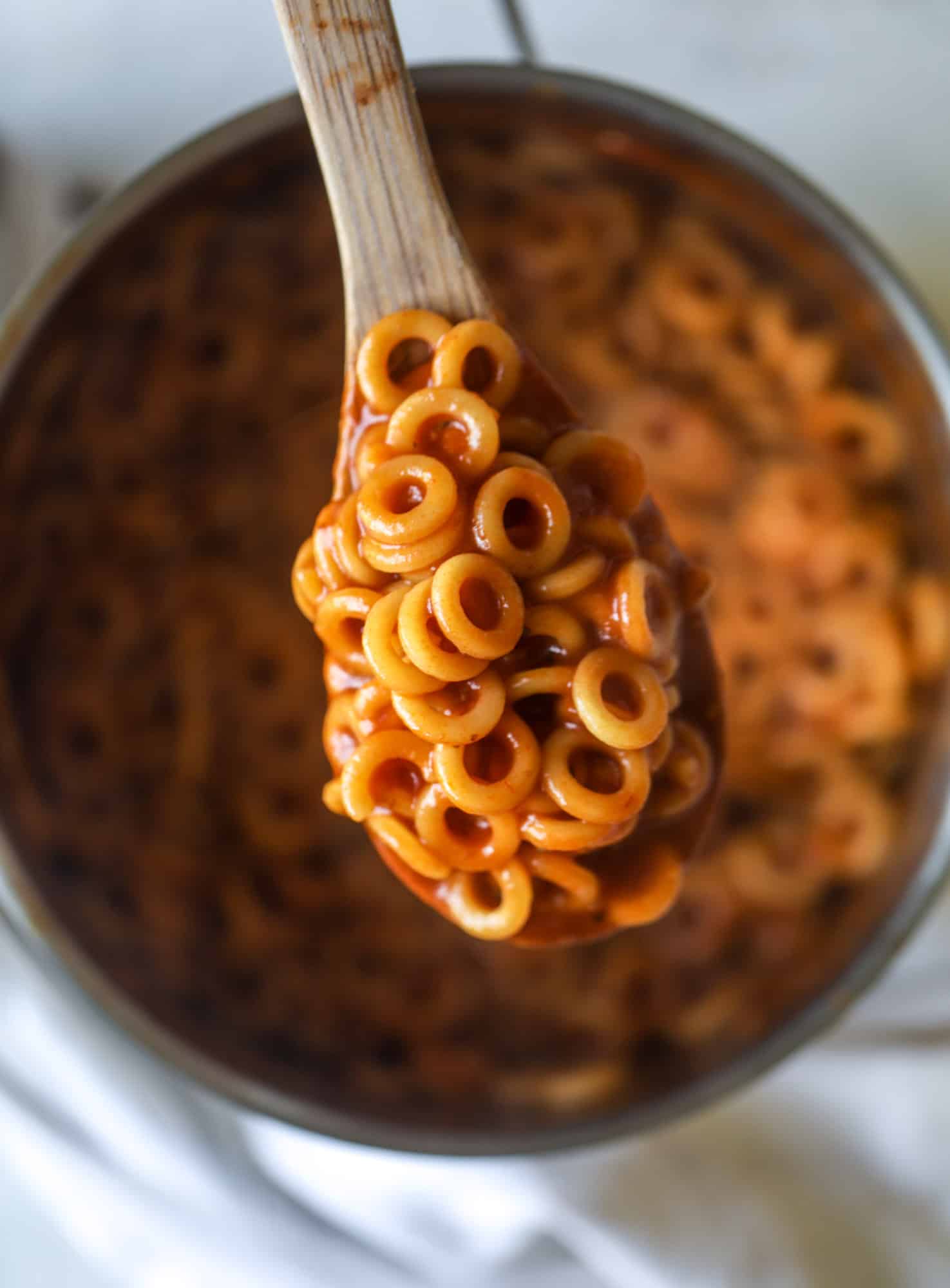 These homemade spaghettios are the ultimate comfort food! They come together in less than 30 minutes, are super easy and flavorful and topped with crispy crunchy manchego cheese that takes the taste over the top! I howsweeteats.com #homemade #spaghettios